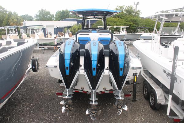 2024 Fountain 34 SC boat with triple outboard engines, displayed in a marina.