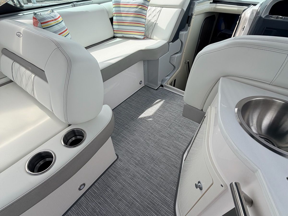 Interior of a Regal 33 Express with gray carpet and white seating.