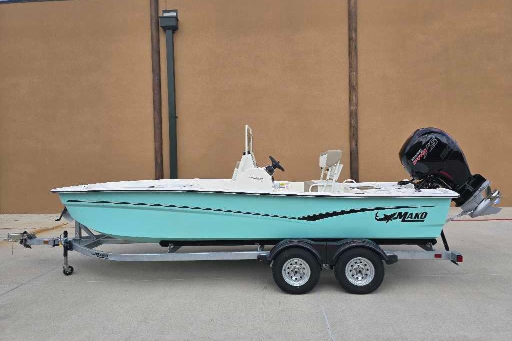 2026 Mako Pro Skiff 19 CC boat on trailer, side view, teal color.