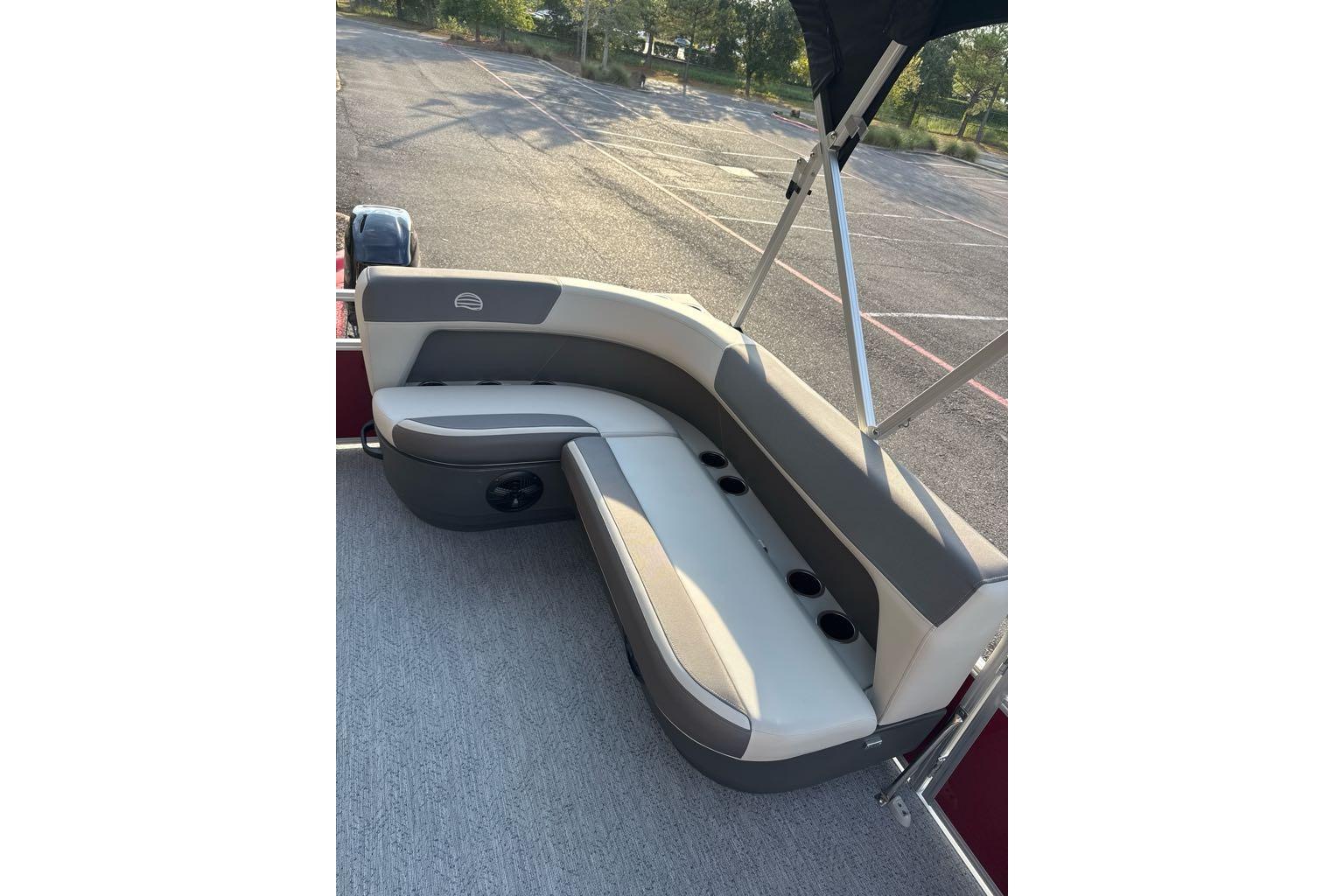2026 Sun Tracker Bass Buggy 16 XL Select pontoon boat seating area with cup holders.