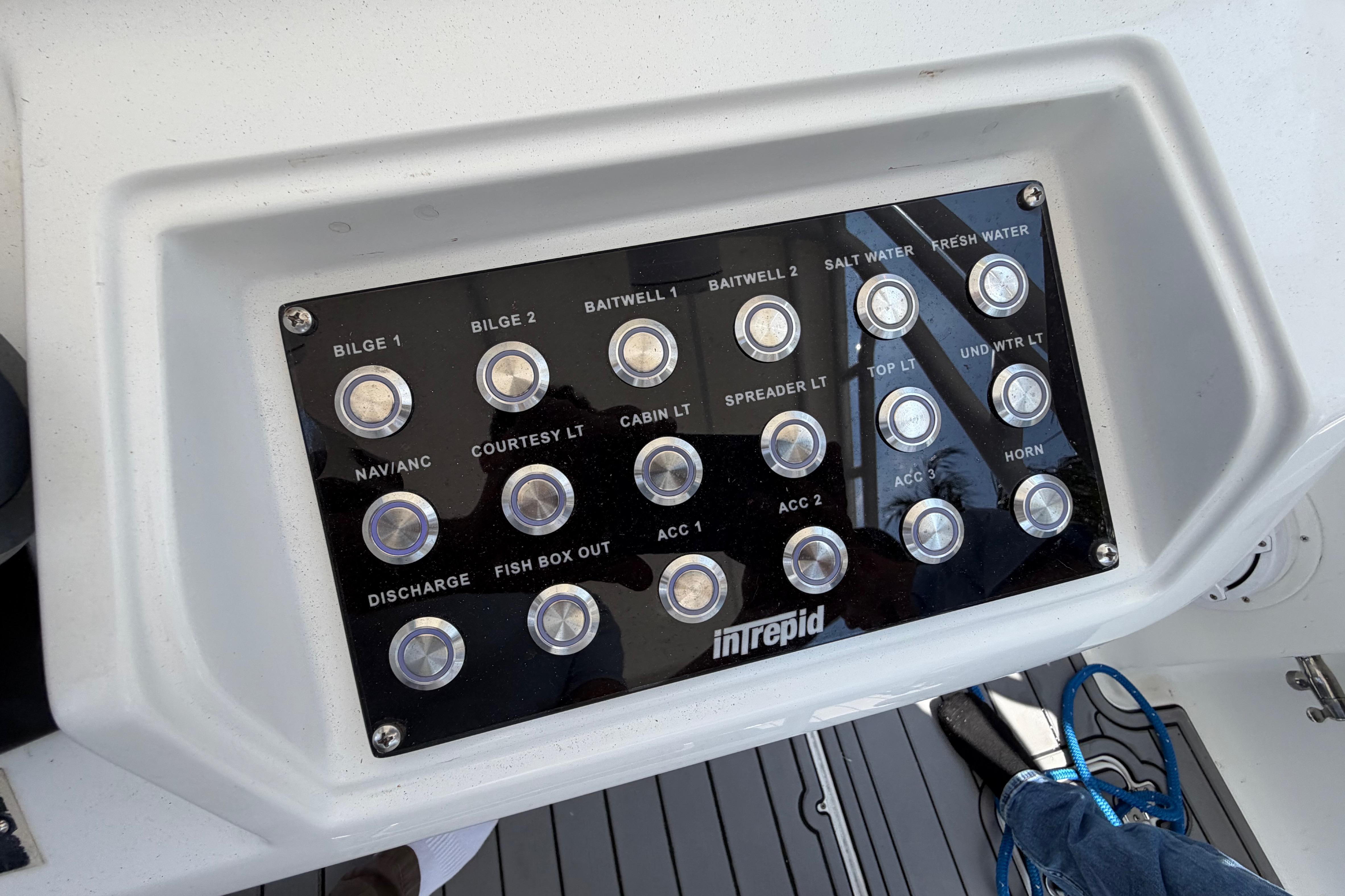 Control panel of a 2003 Intrepid 323 Cuddy boat with labeled switches.