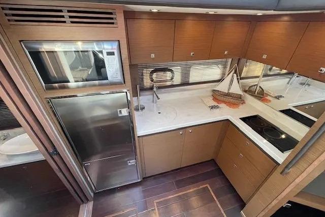 Luxurious kitchen interior of 2016 Sea Ray Sundancer 510 yacht with modern appliances.