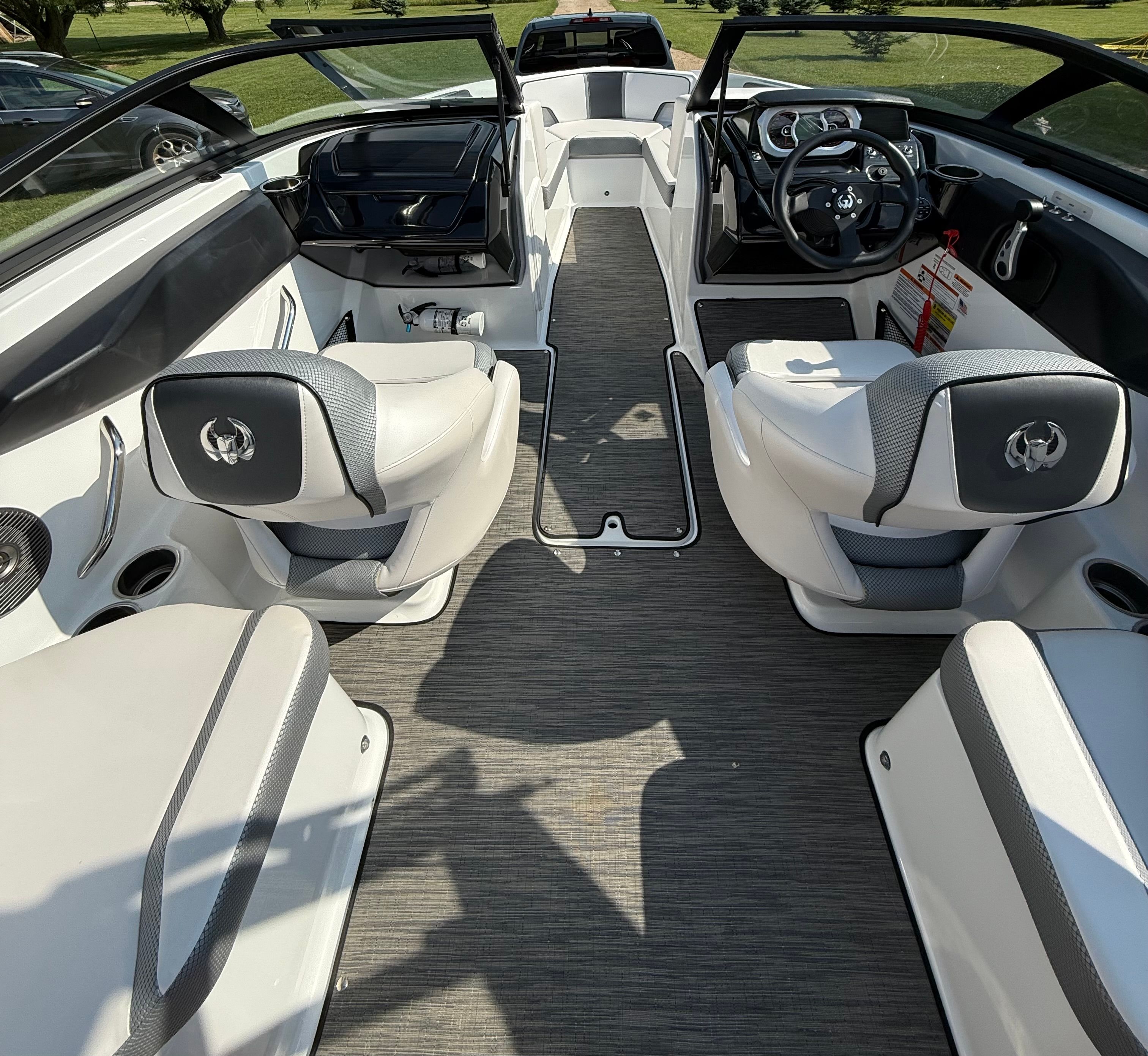 The image shows the interior of a 2023 Scarab 195 ID boat with modern seating and sleek design.