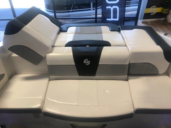 2023 Chaparral 21 Surf boat interior seating, featuring sleek white and gray upholstery.