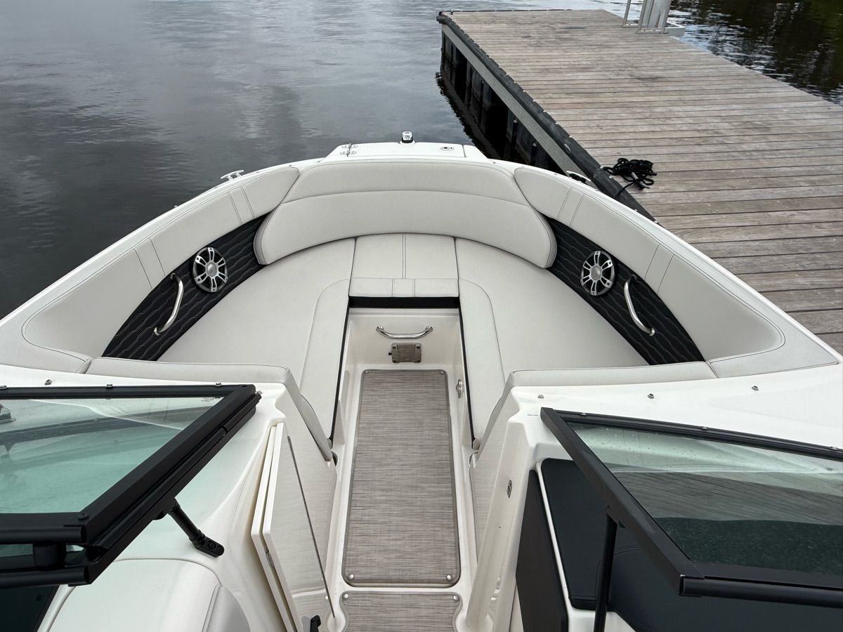 The image shows the bow area of a 2024 Sea Ray SPX 230 Outboard with white upholstery.