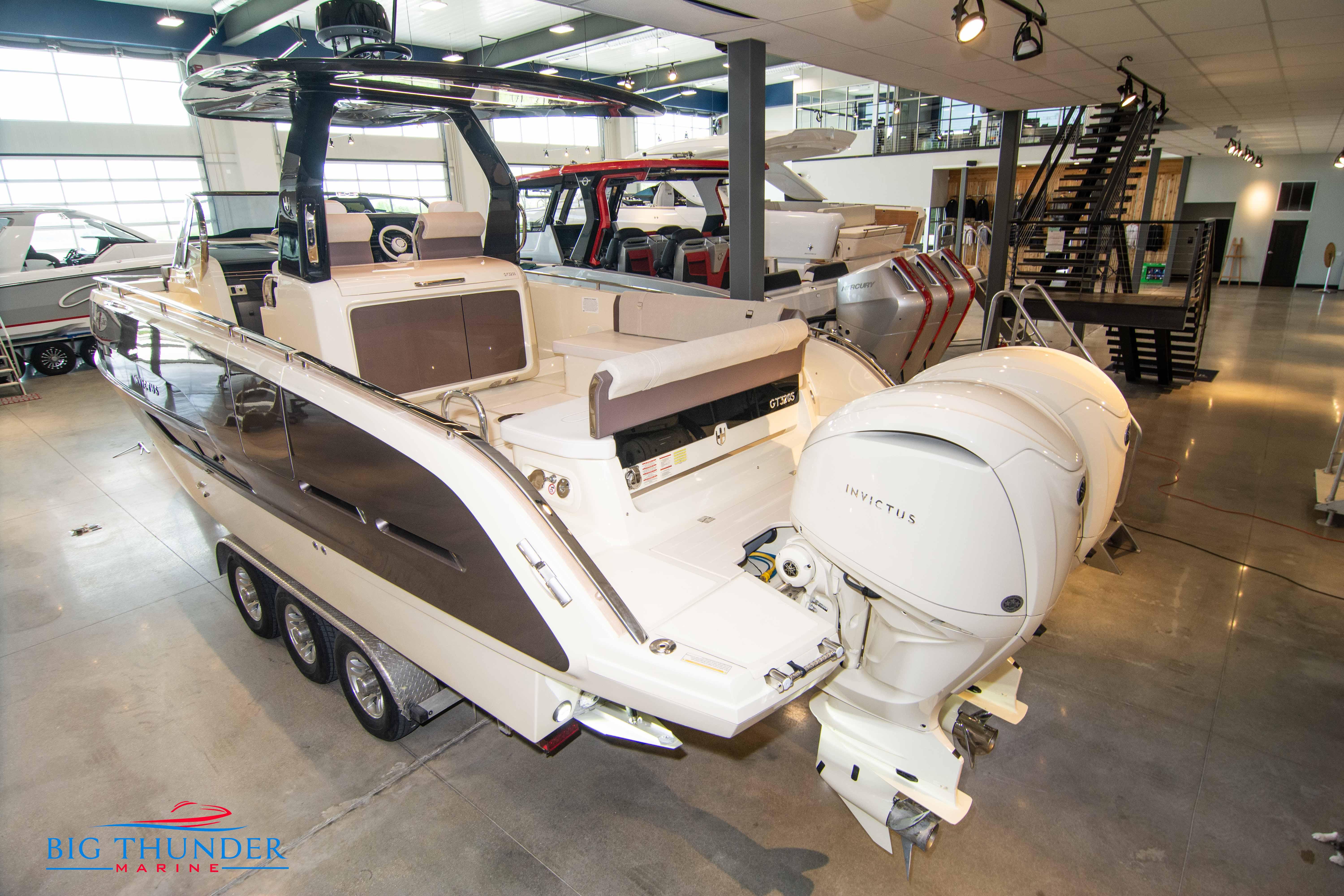 2024 Invictus GT320S luxury motorboat displayed in a showroom.
