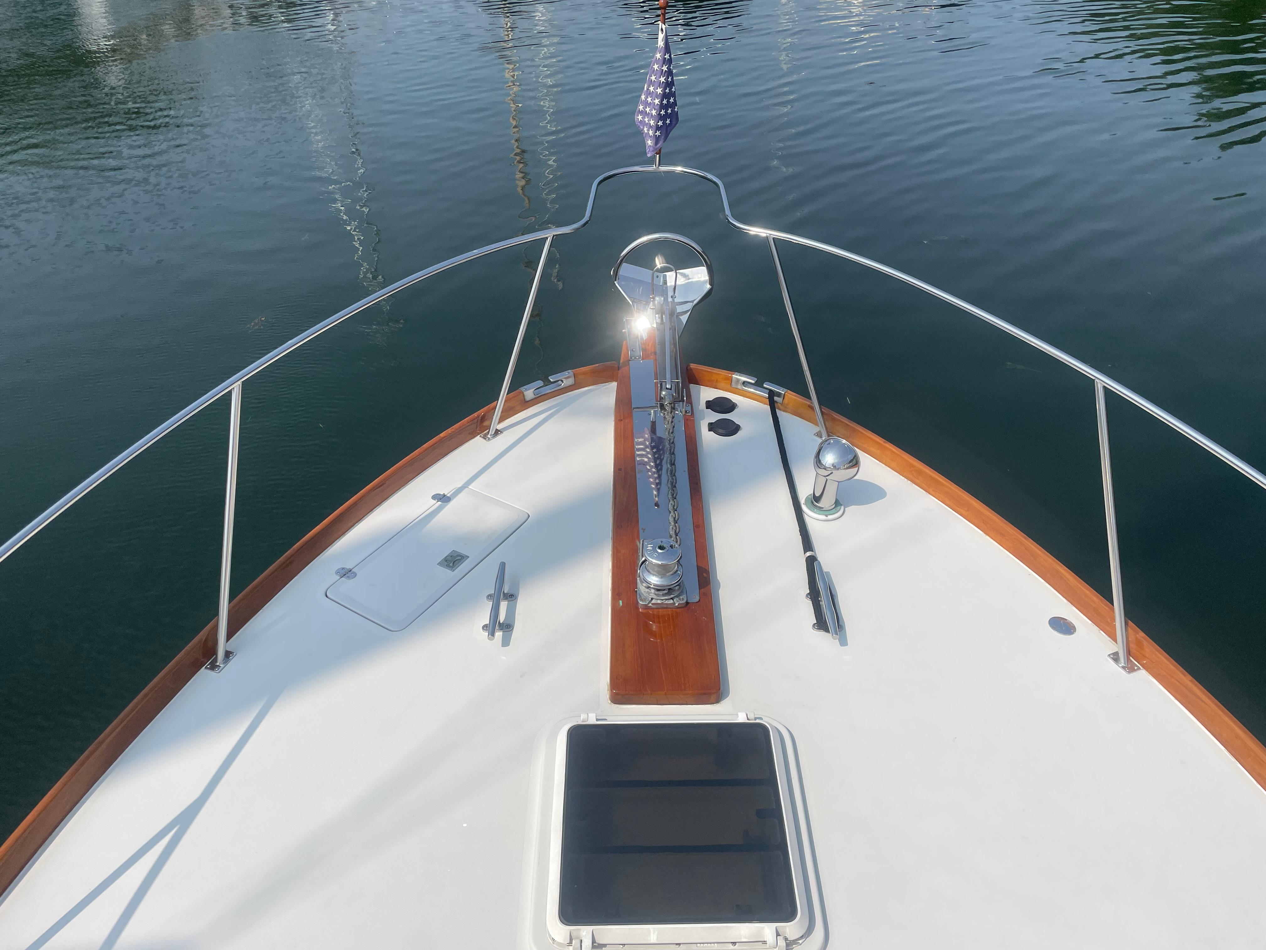 Bow view of 1997 Lyman-Morse Custom Flybridge yacht with American flag.