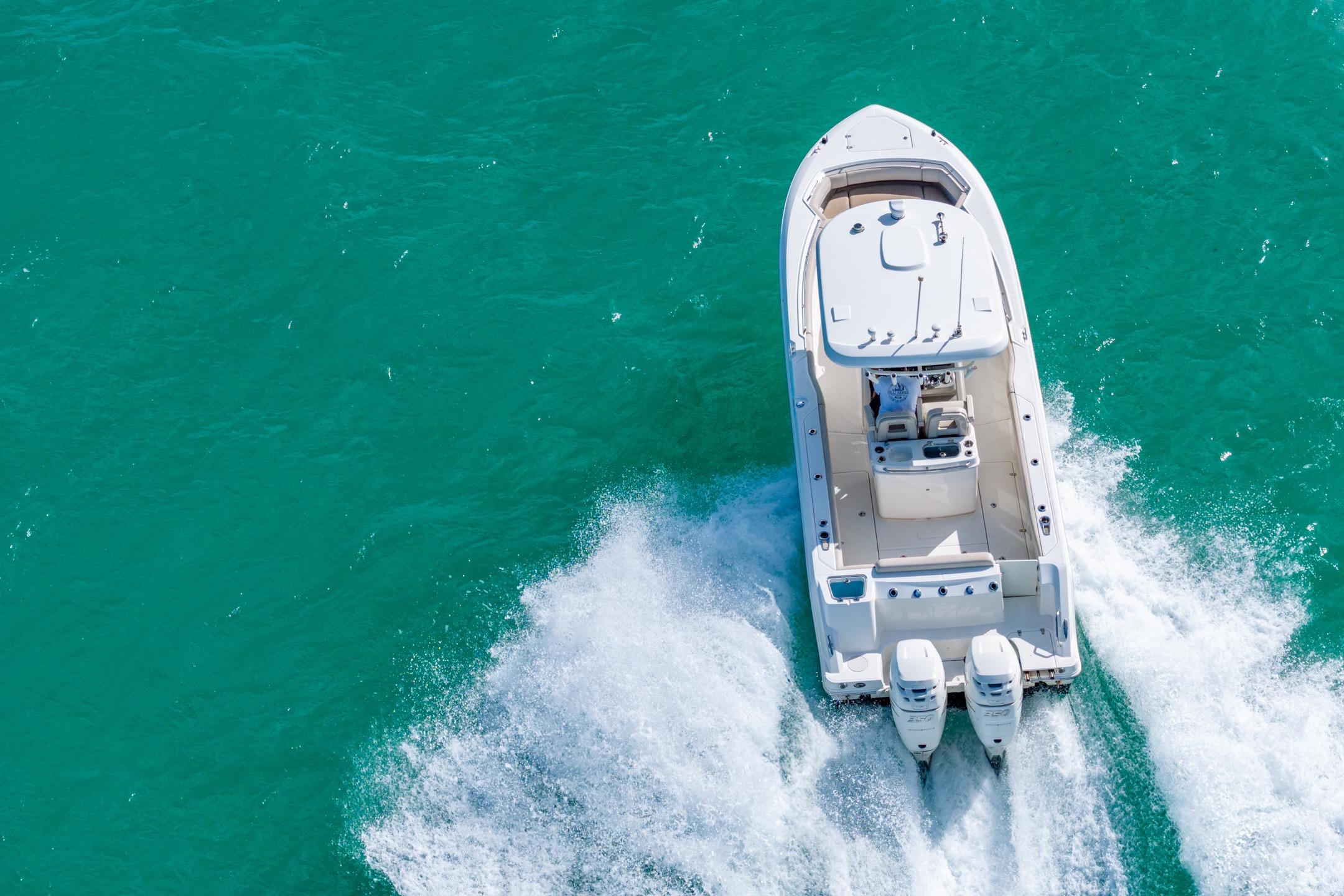 2016 Boston Whaler 280 Outrage cruising on turquoise water, aerial view.