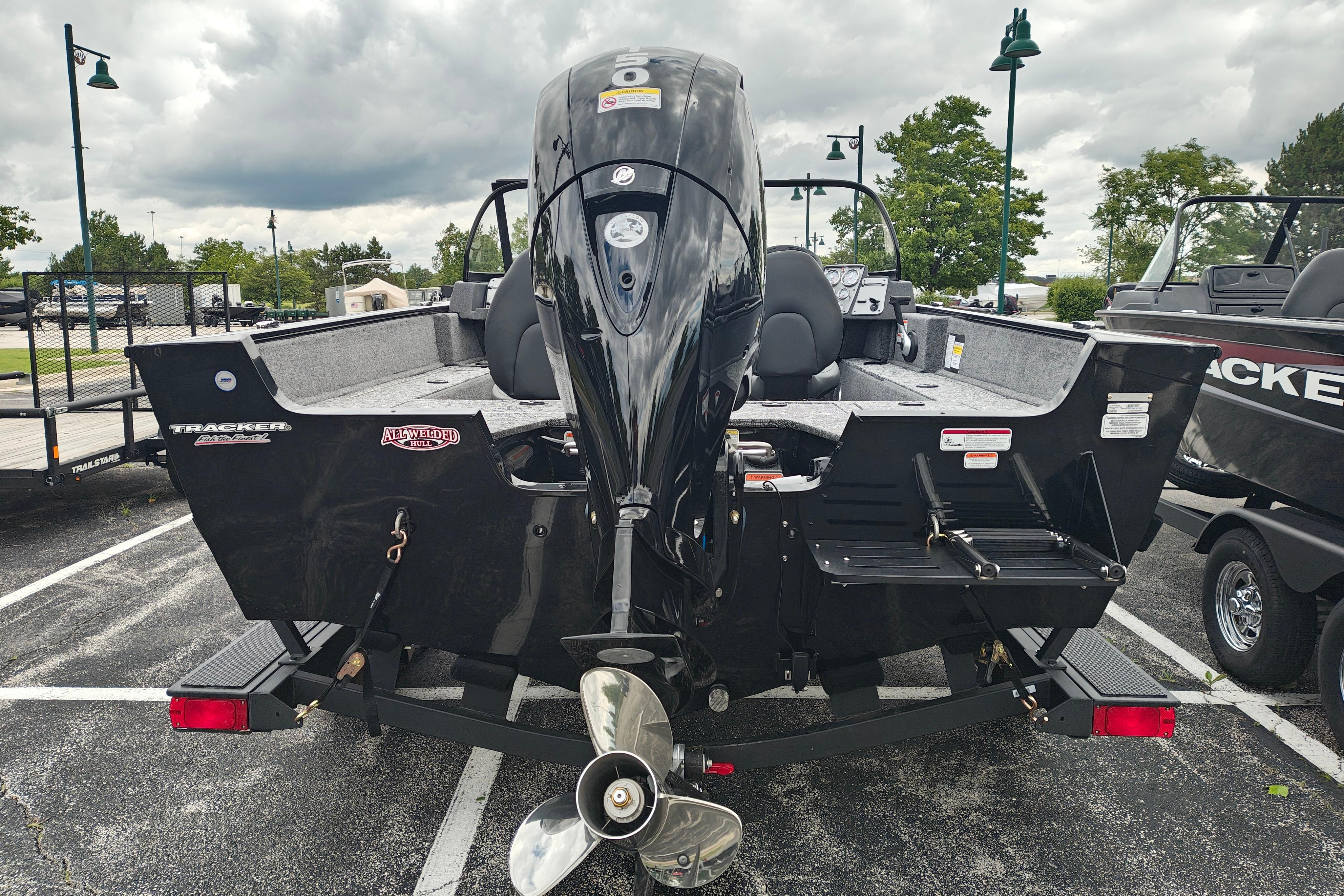 2026 Tracker Pro Guide V-175 WT boat with powerful outboard motor in parking lot.