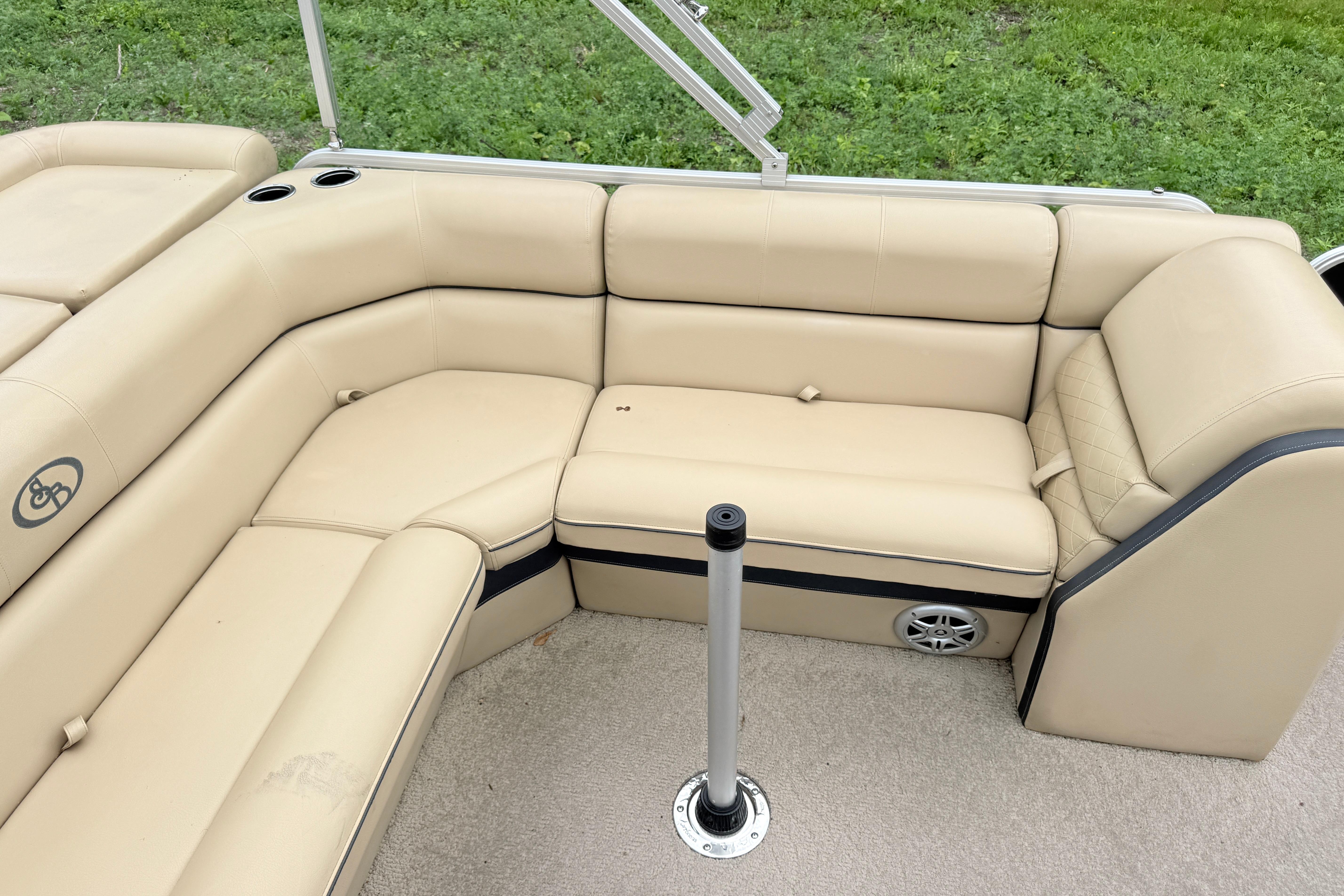 2013 South Bay 522CR boat interior with beige seating and cup holders.