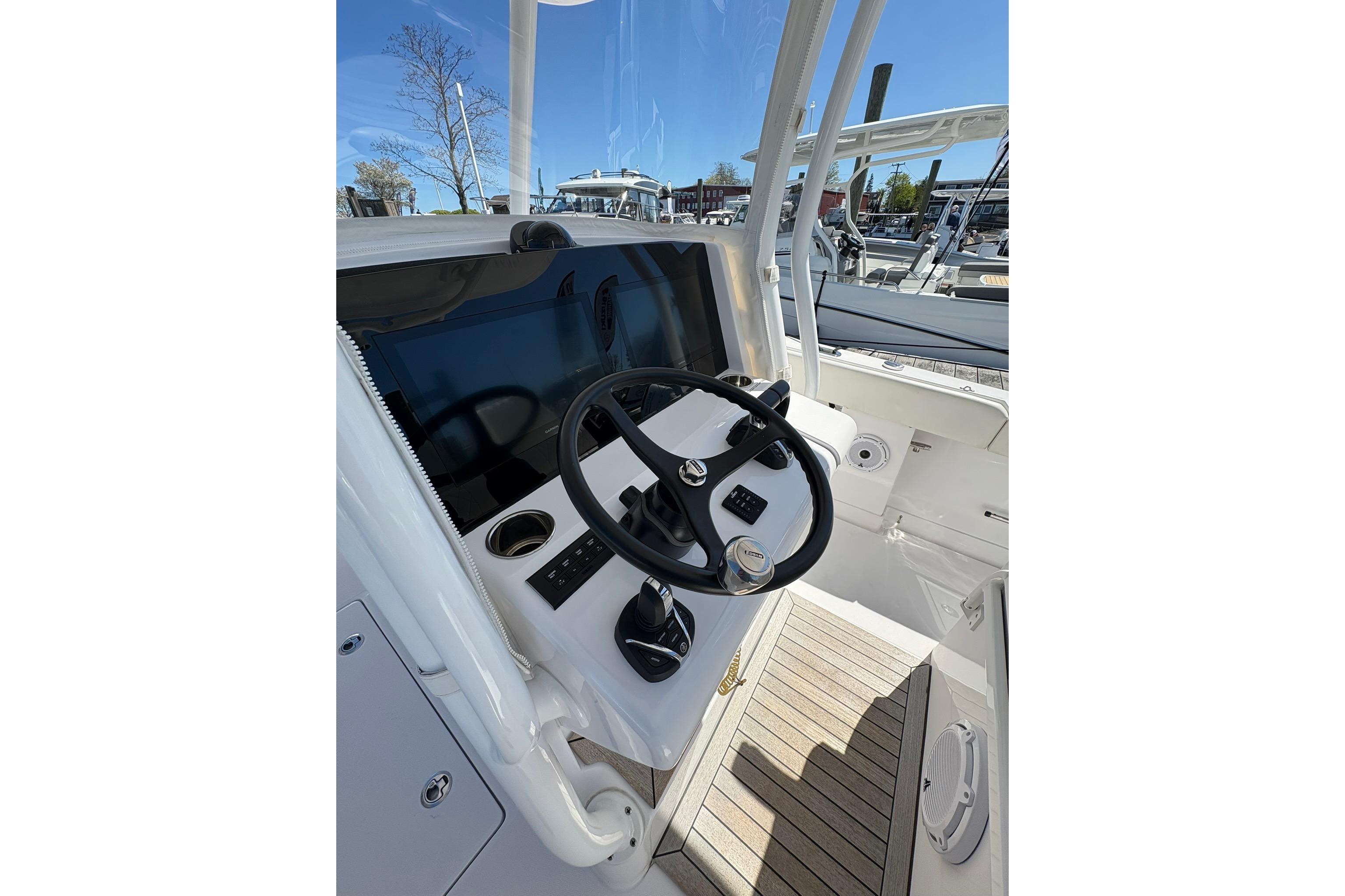 Helm of 2023 Jupiter 30 boat with steering wheel and navigation display.