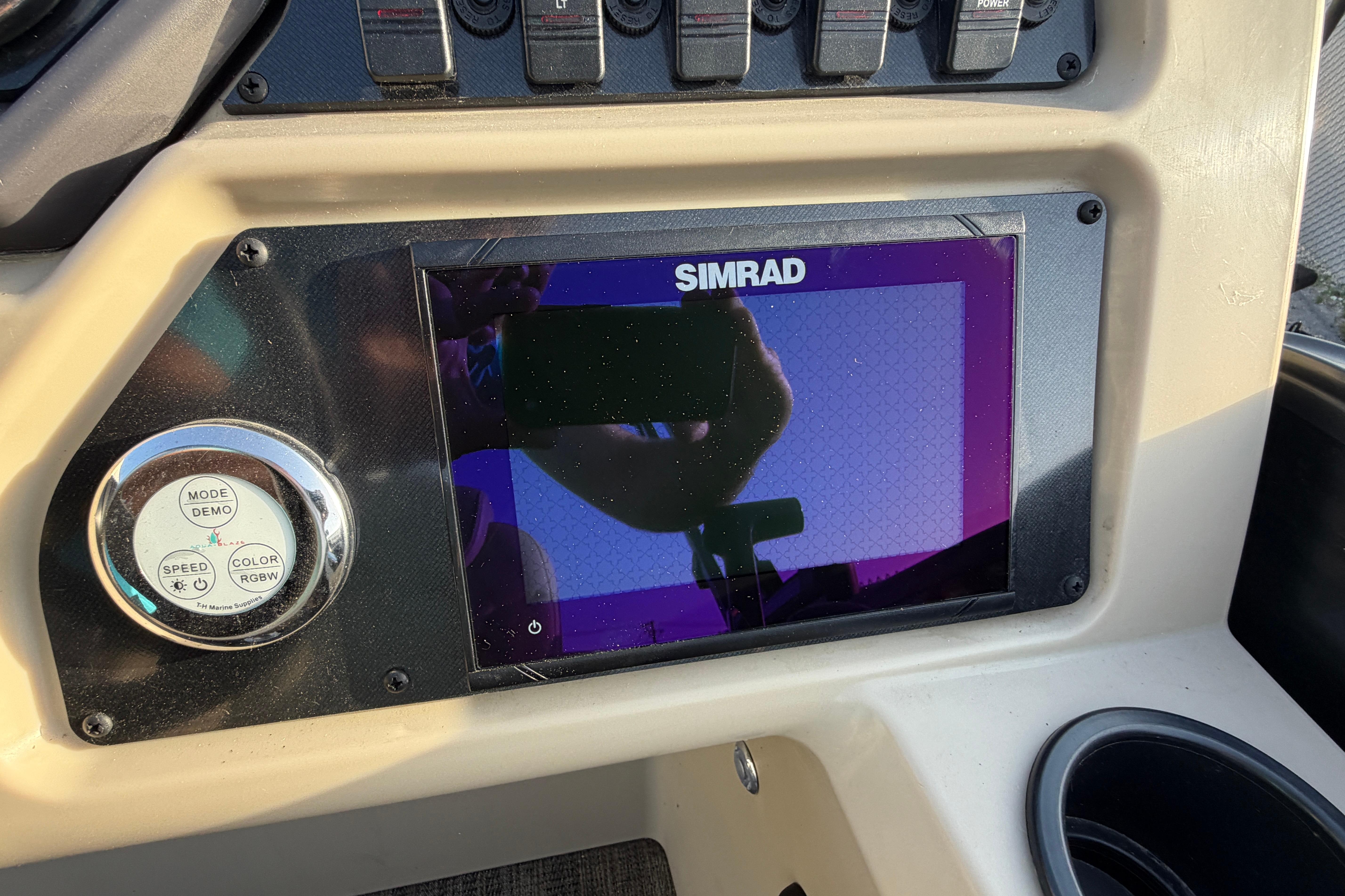 Dashboard of 2023 Godfrey Sweetwater 2286 C with Simrad display and control panel.