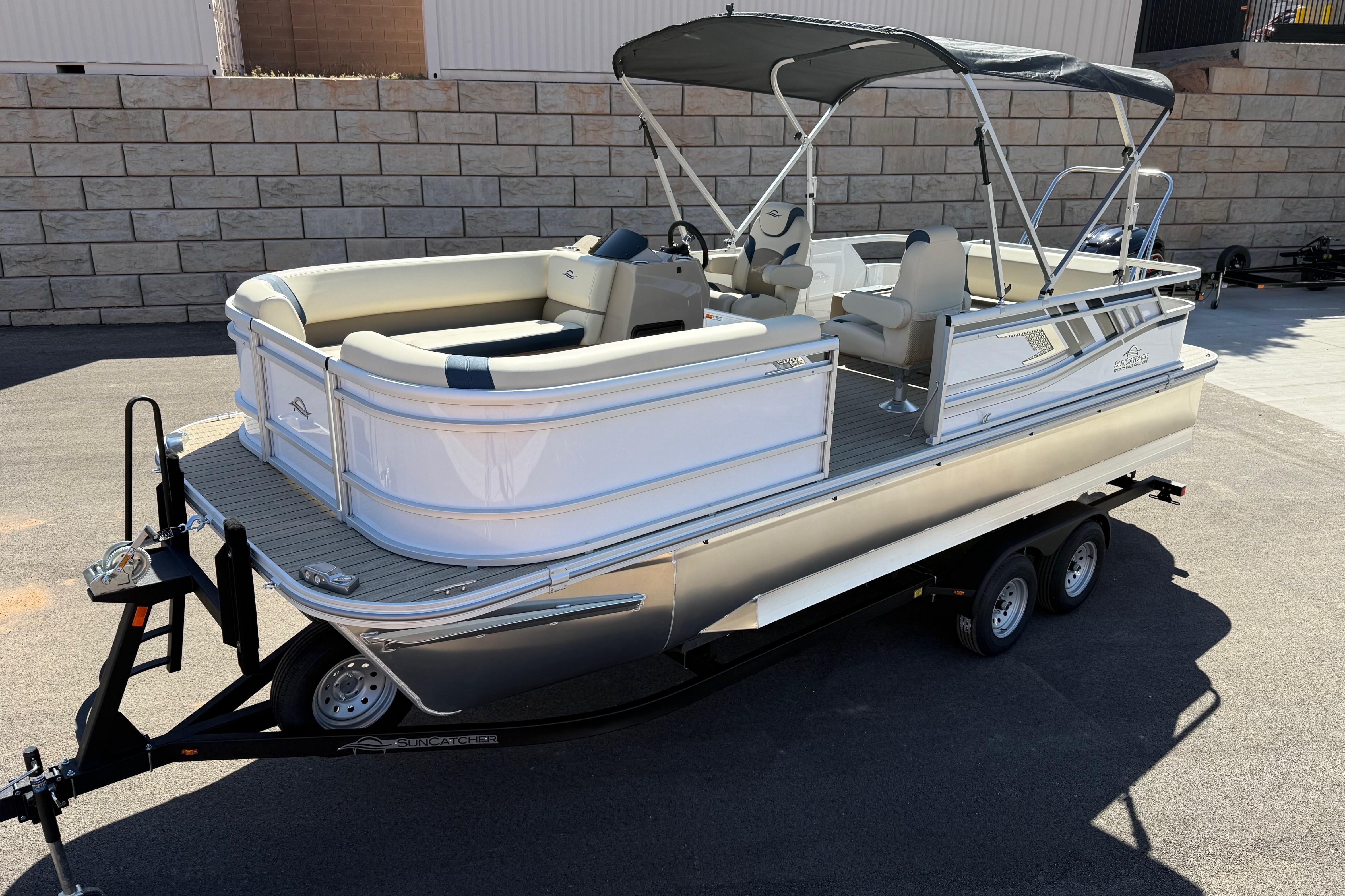 2026 SunCatcher Select 322SL pontoon boat on trailer, featuring sleek design and spacious seating.