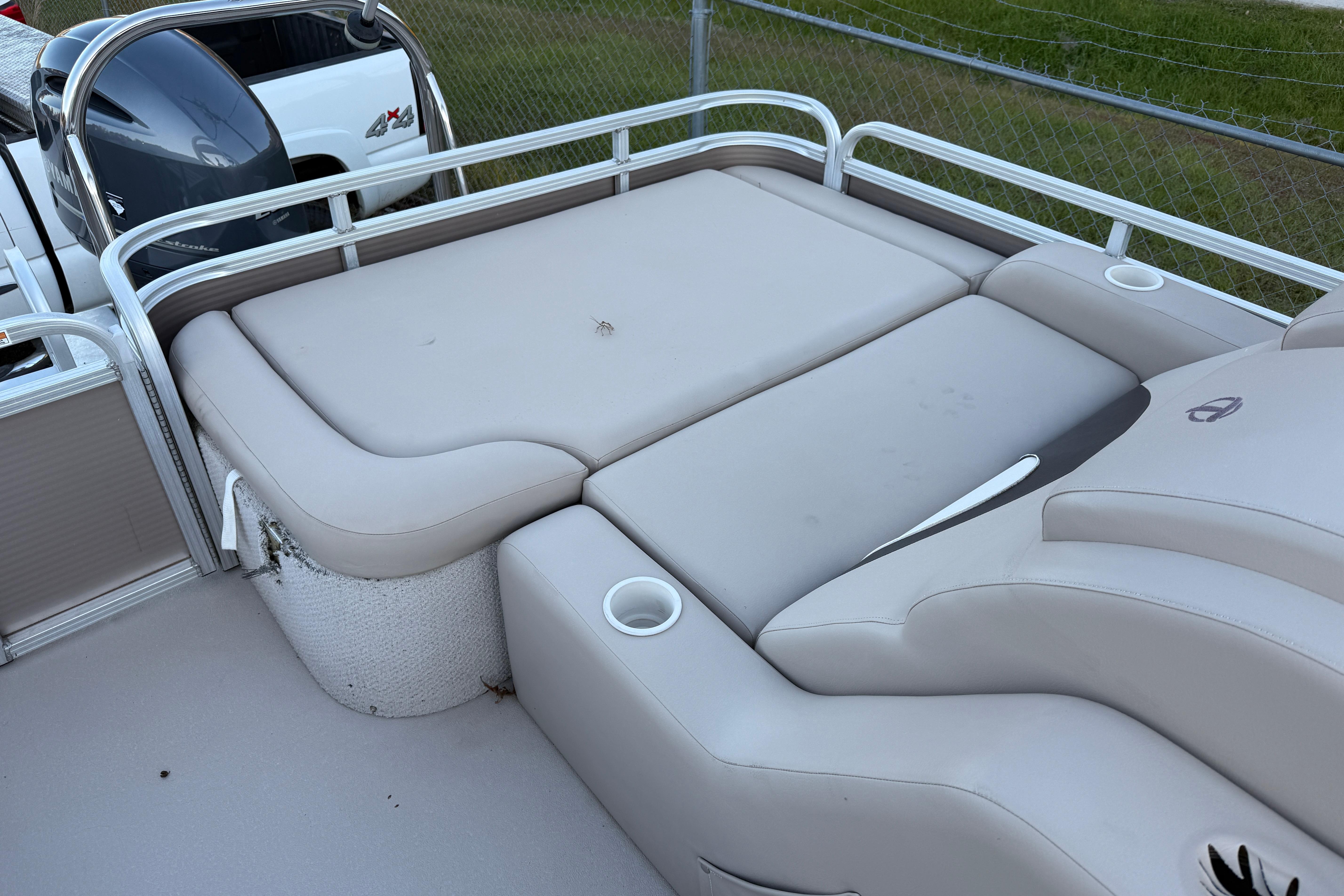 2011 Tahoe Pontoon 2485 DRL boat with beige seating and cup holders.