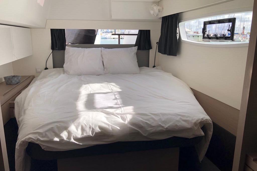 Cozy bedroom interior of 2020 Fountaine Pajot Saona 47 catamaran with natural light.