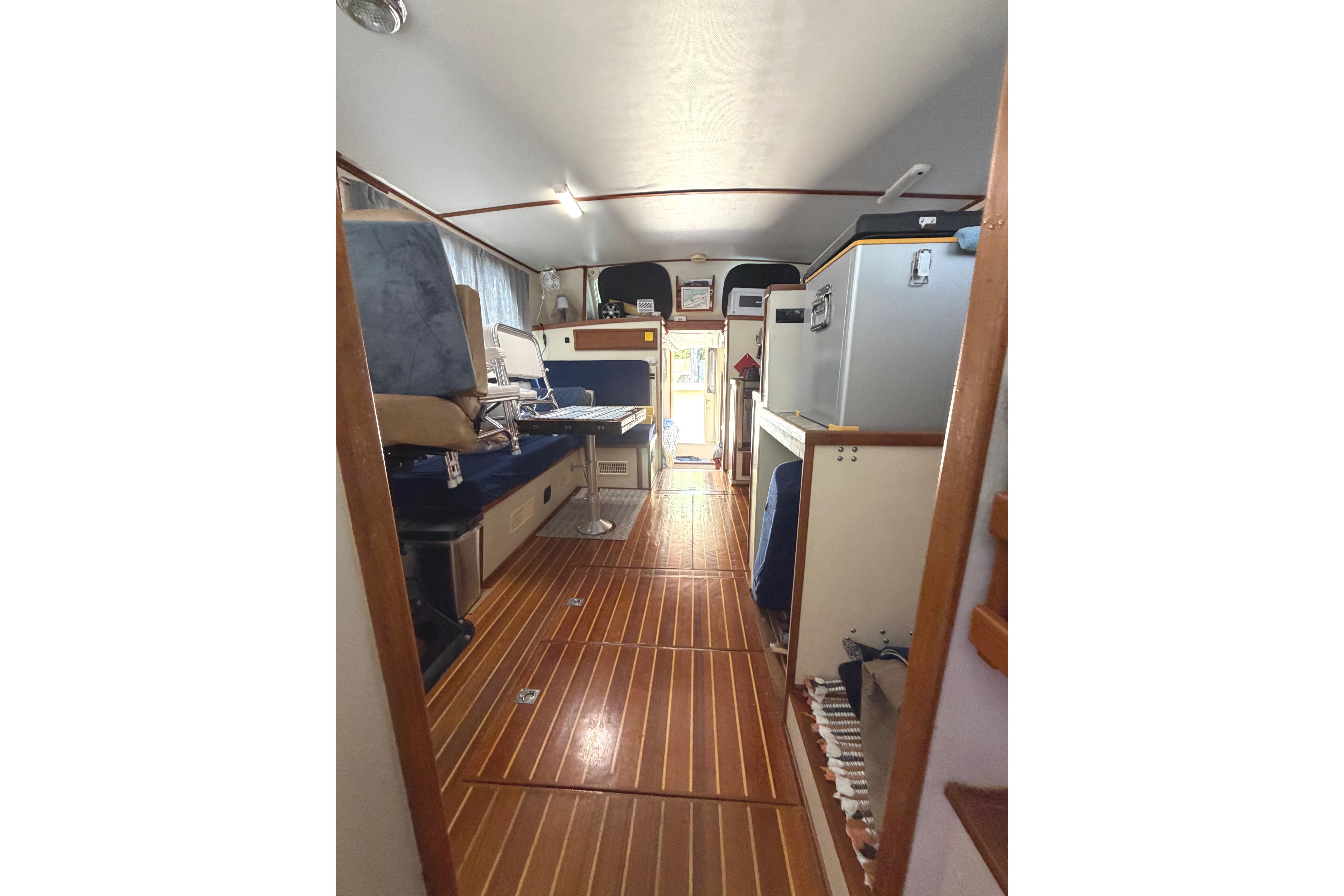 Interior of a 1997 Rosborough Trawler showcasing wooden flooring and seating area.