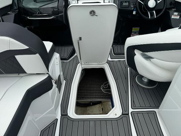 Interior of 2018 Monterey 258 Super Sport boat with open storage compartment.