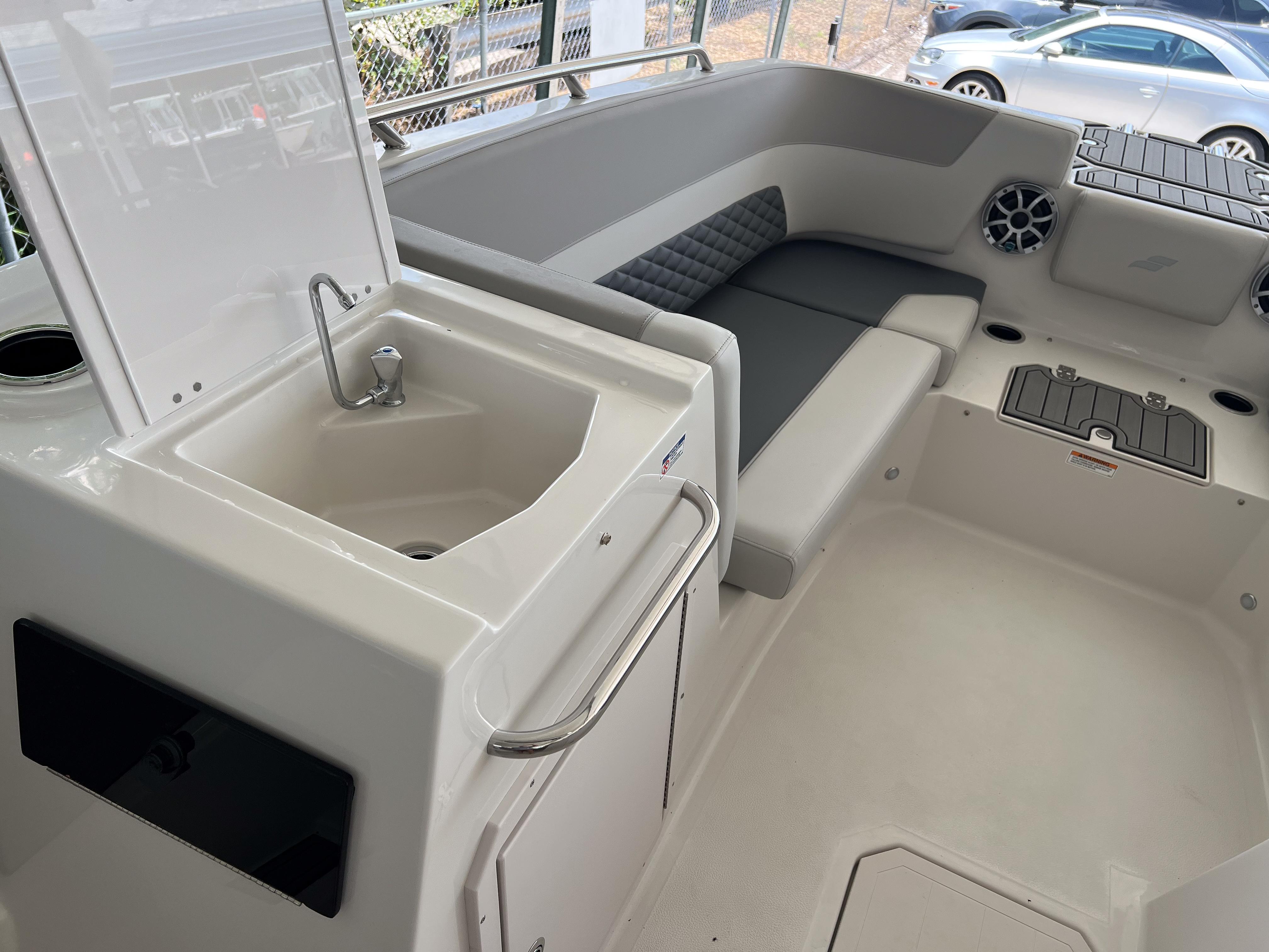 2026 Starcraft SVX 231 OB boat interior with sink, seating, and storage compartments.