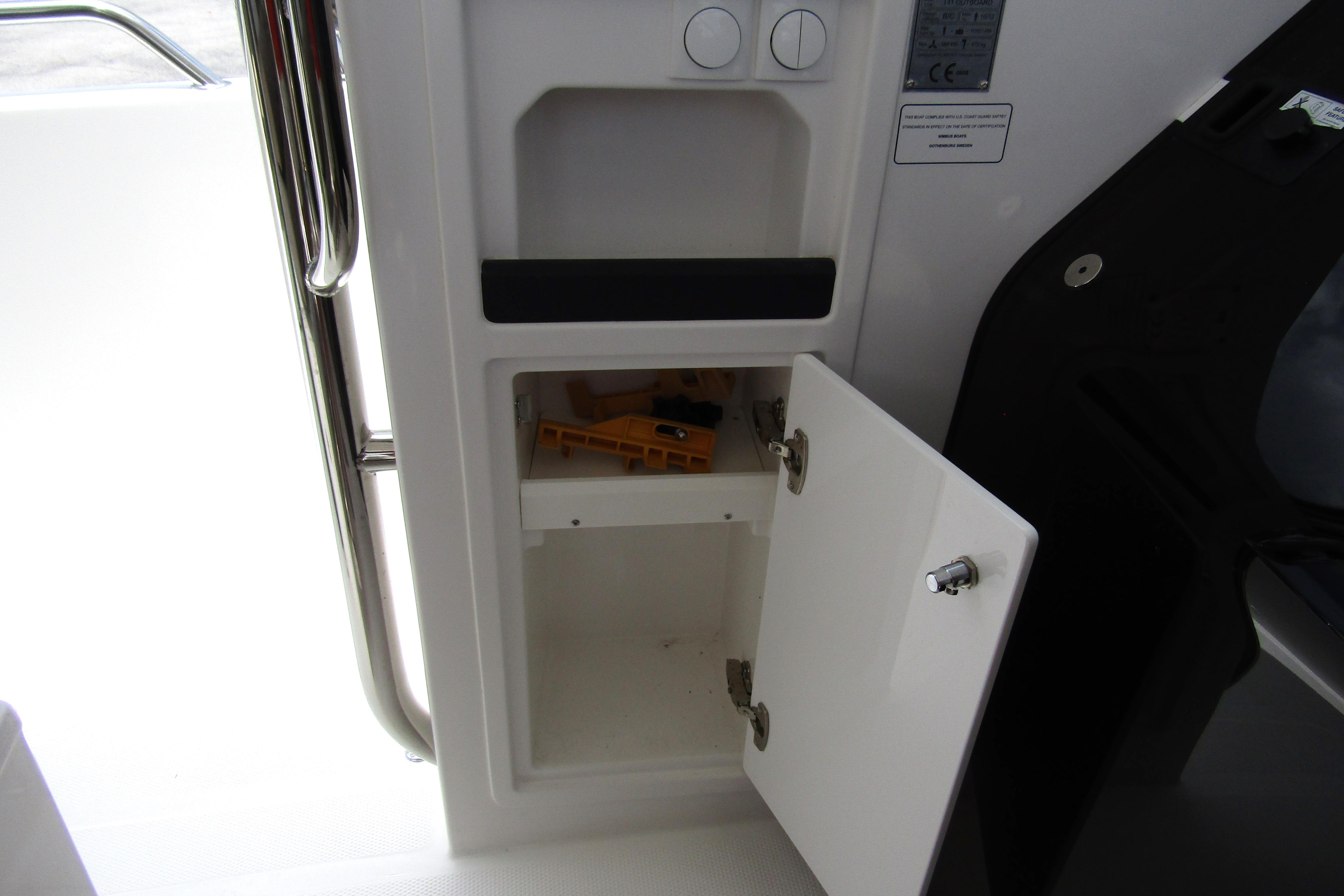 Open storage compartment on 2025 Nimbus Tender 11 boat interior.
