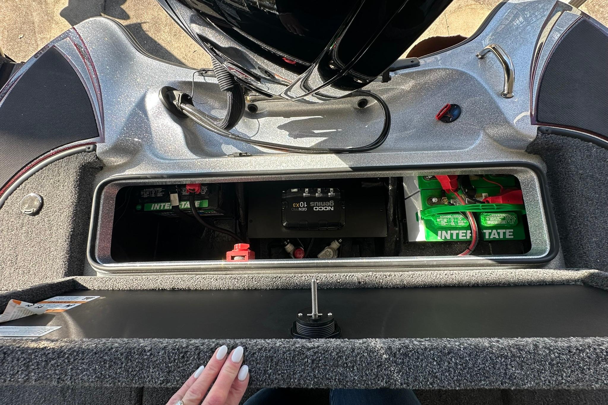 2026 Triton 179 TrX boat battery compartment with Interstate batteries and NOCO Genius charger.