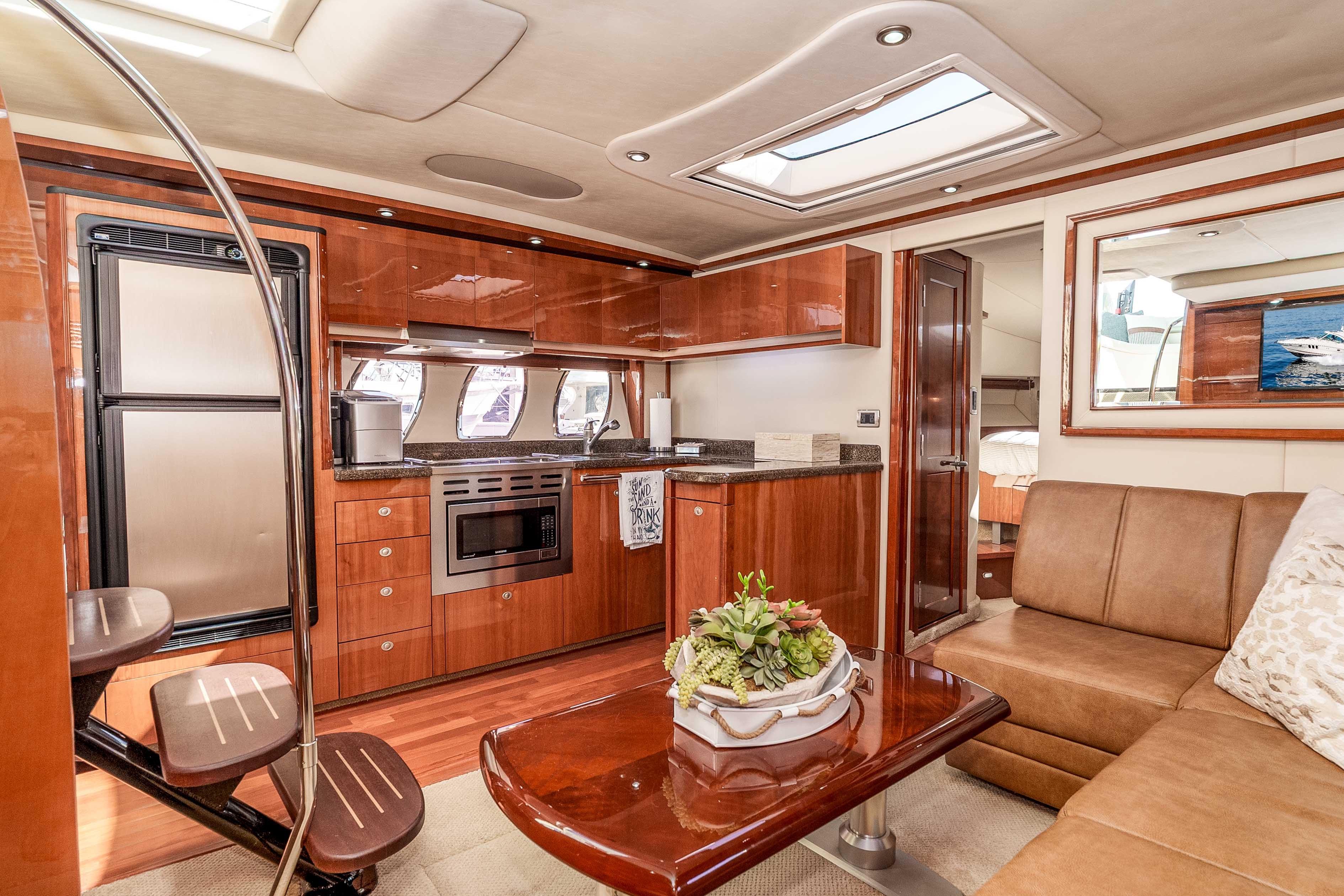 Luxurious interior of 2007 Sea Ray 48 Sundancer yacht with modern kitchen and seating area.