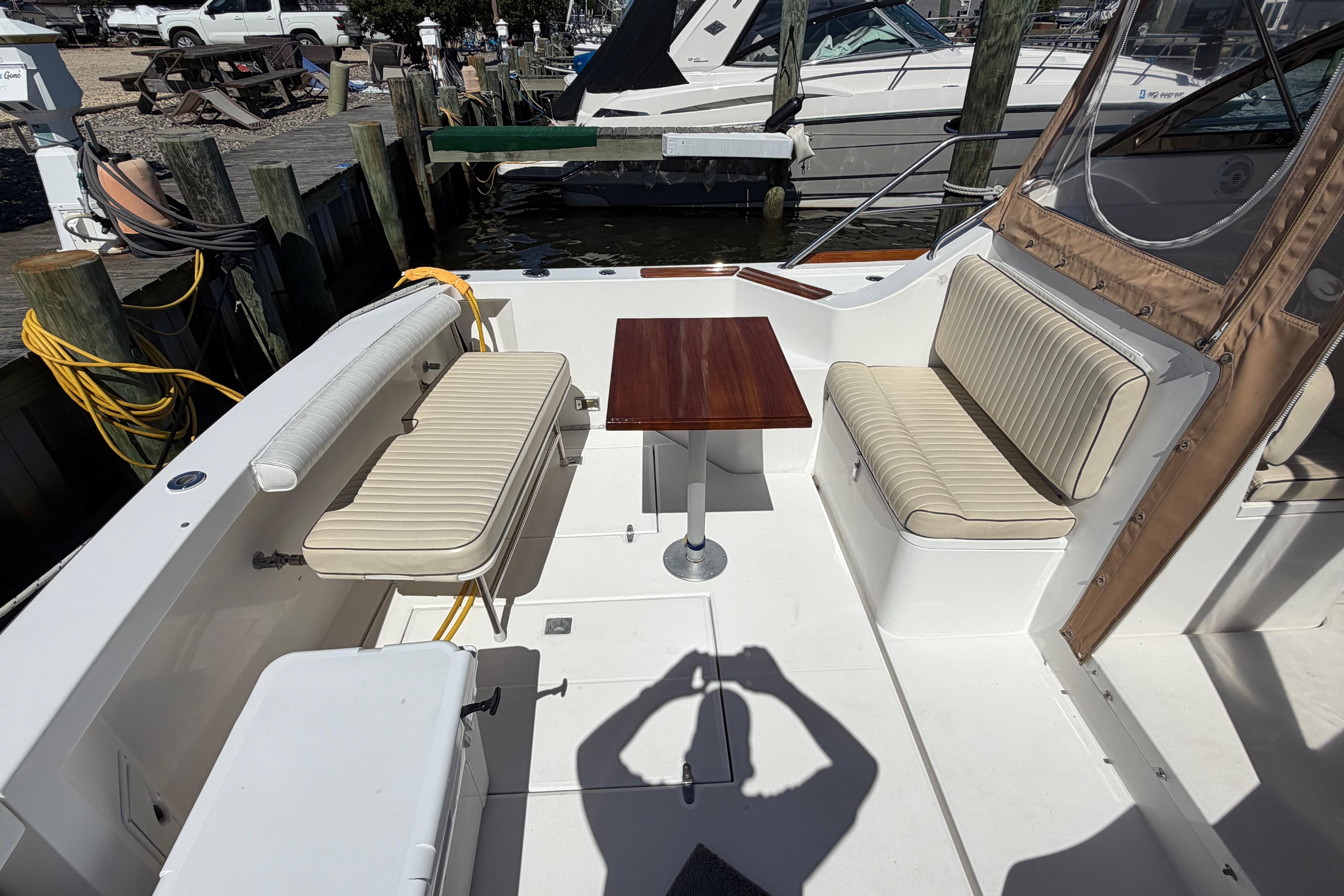 2000 Sabreline 36 Express boat interior with seating and table at dock.