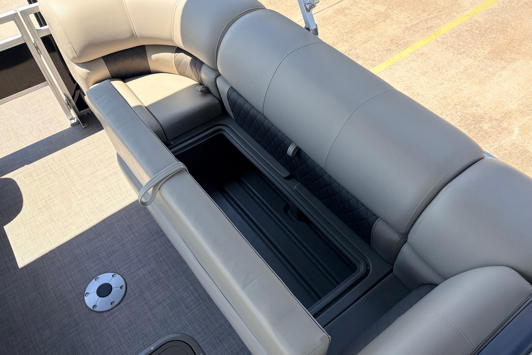 2024 Sun Tracker SportFish 22 XP3 boat interior with cushioned seating and storage compartment.