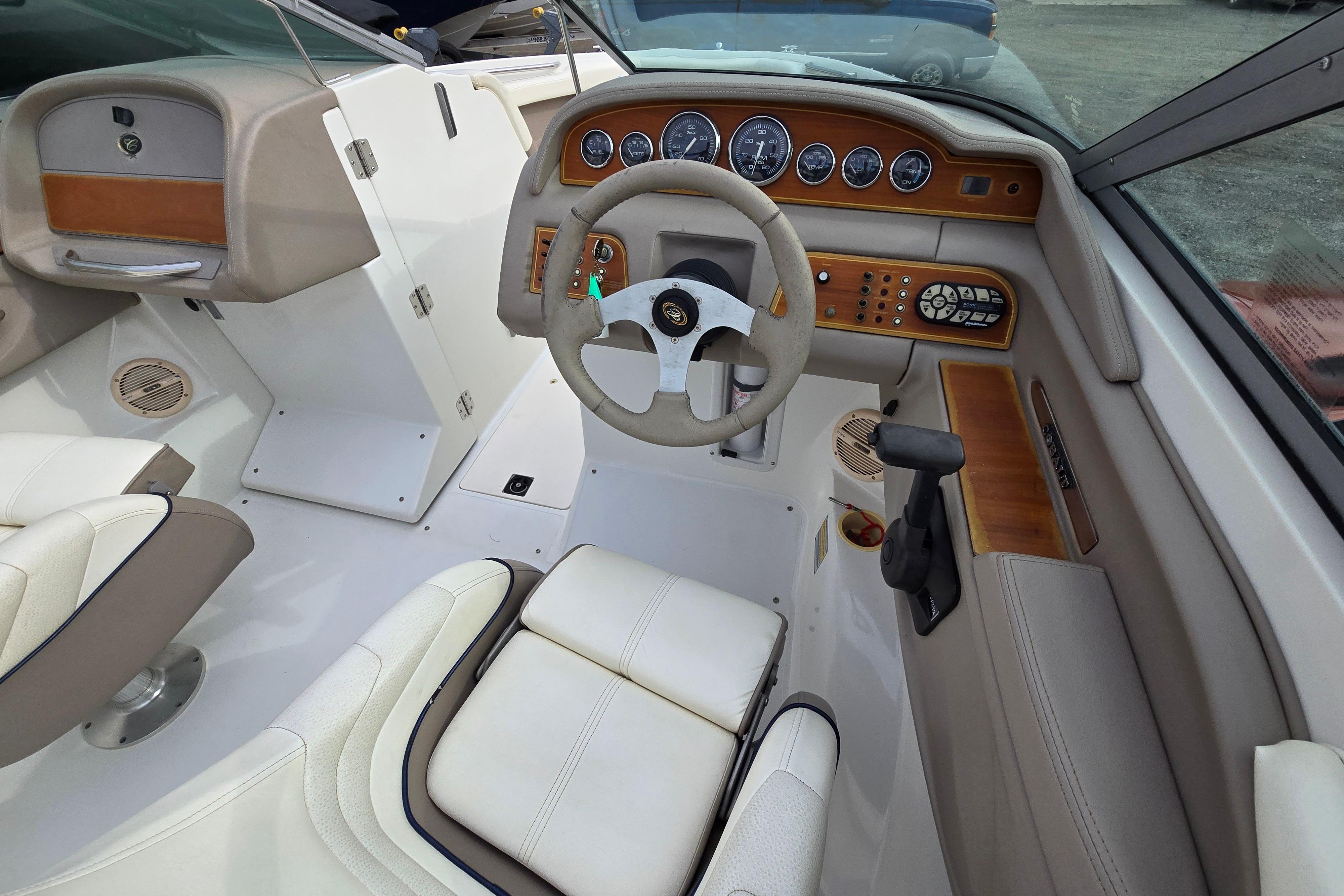 Interior of a 2000 Cobalt 246 boat featuring a steering wheel and control panel.