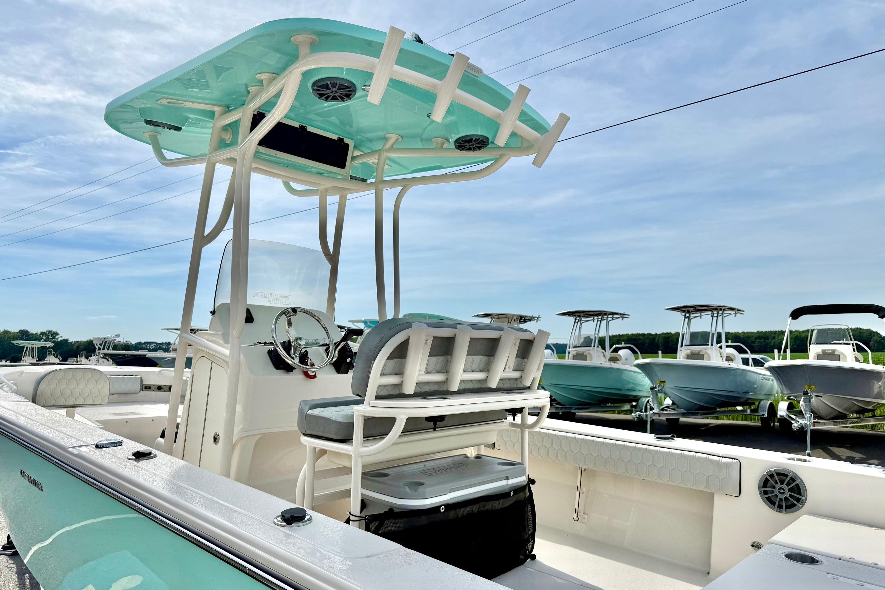 2026 Carolina Skiff 24 Ultra Elite boat with T-top and seating, displayed outdoors.