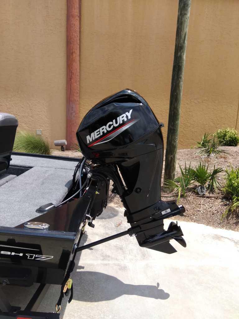 2025 Tracker Panfish 17 boat with Mercury outboard motor, parked outdoors.