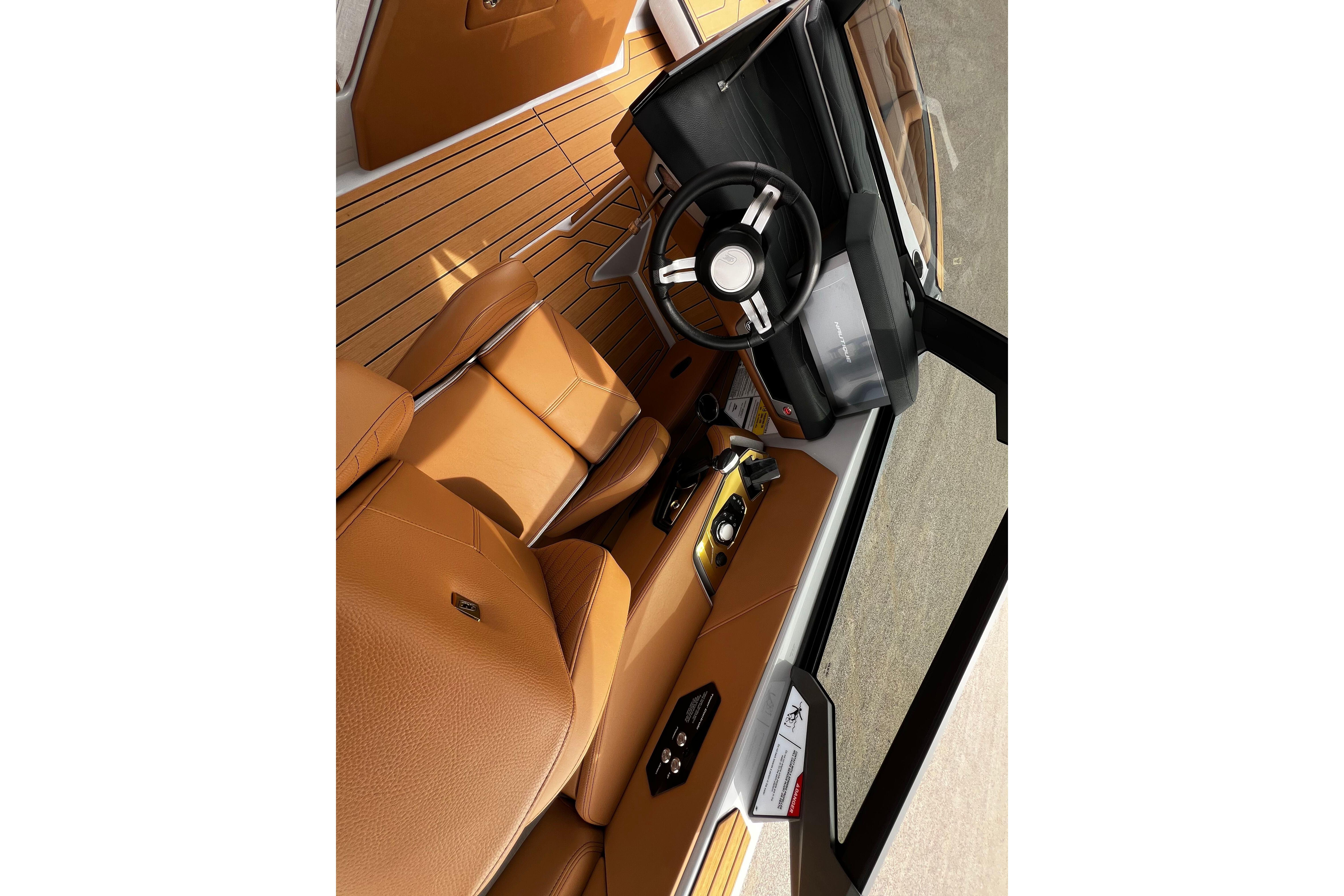 2026 Nautique Super Air Nautique G25 interior with tan leather seats and modern dashboard.