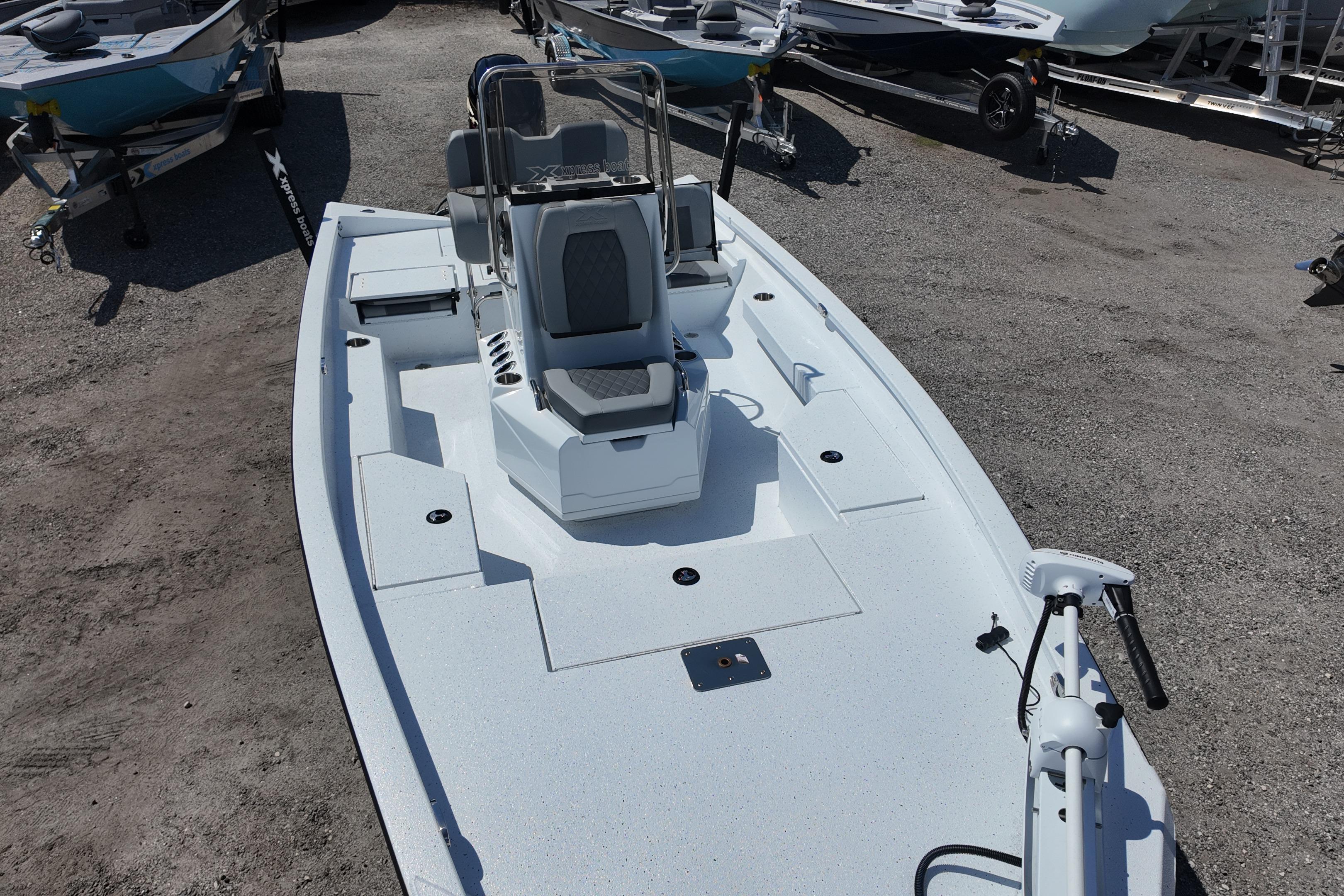 2026 Xpress H20 boat with sleek design, parked on gravel lot.