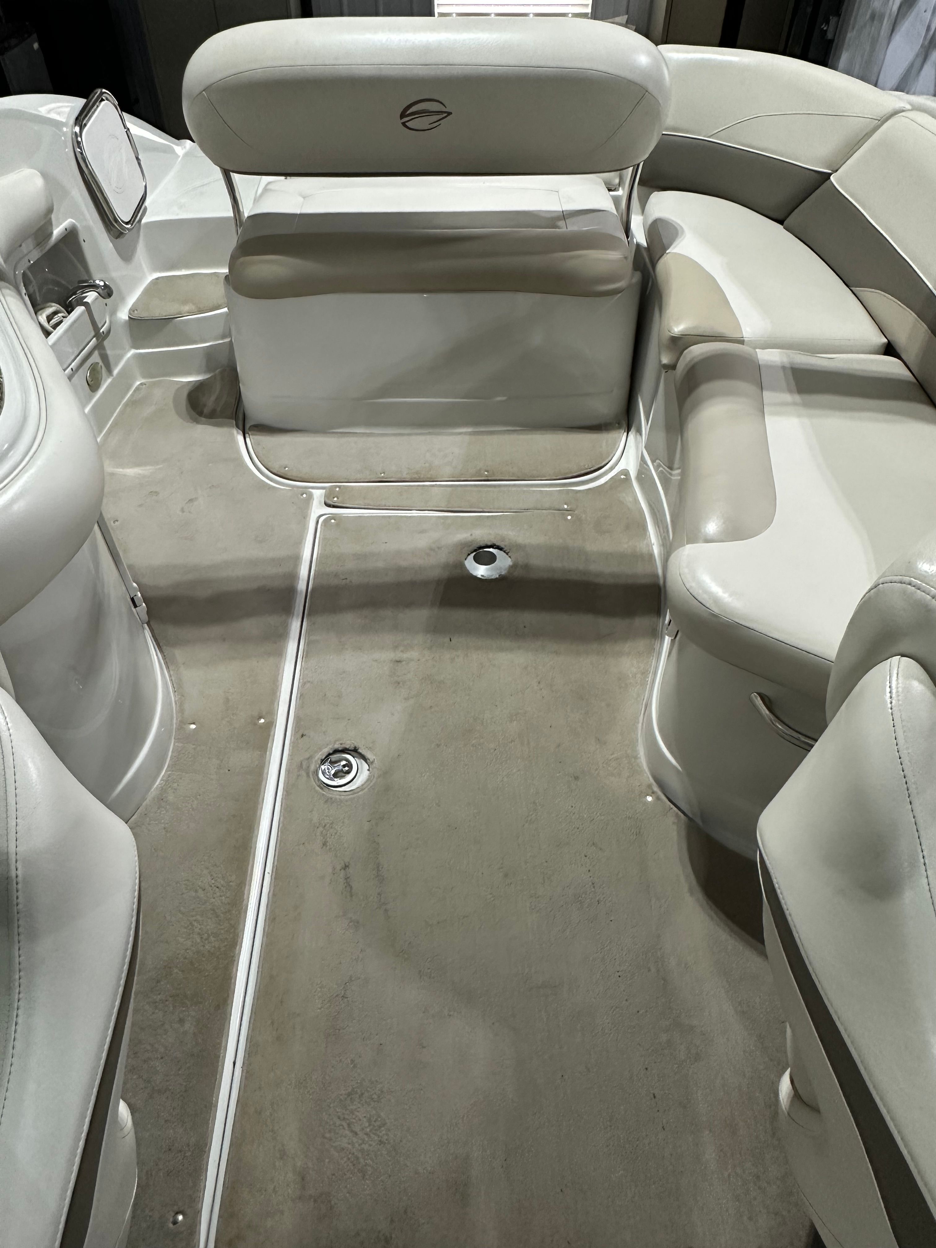 Interior of a 2007 Crownline 252 EX boat with beige seating and carpeted floor.