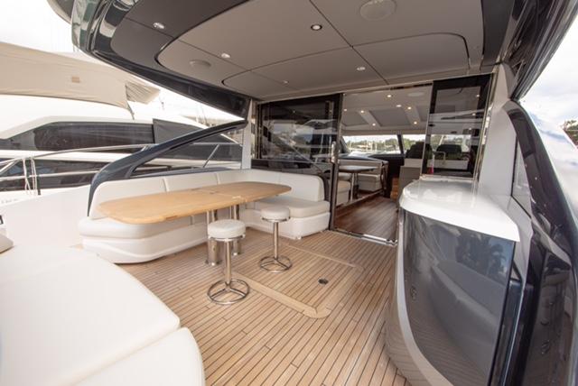 Luxurious 2024 Princess V55 yacht interior with elegant seating and wooden flooring.