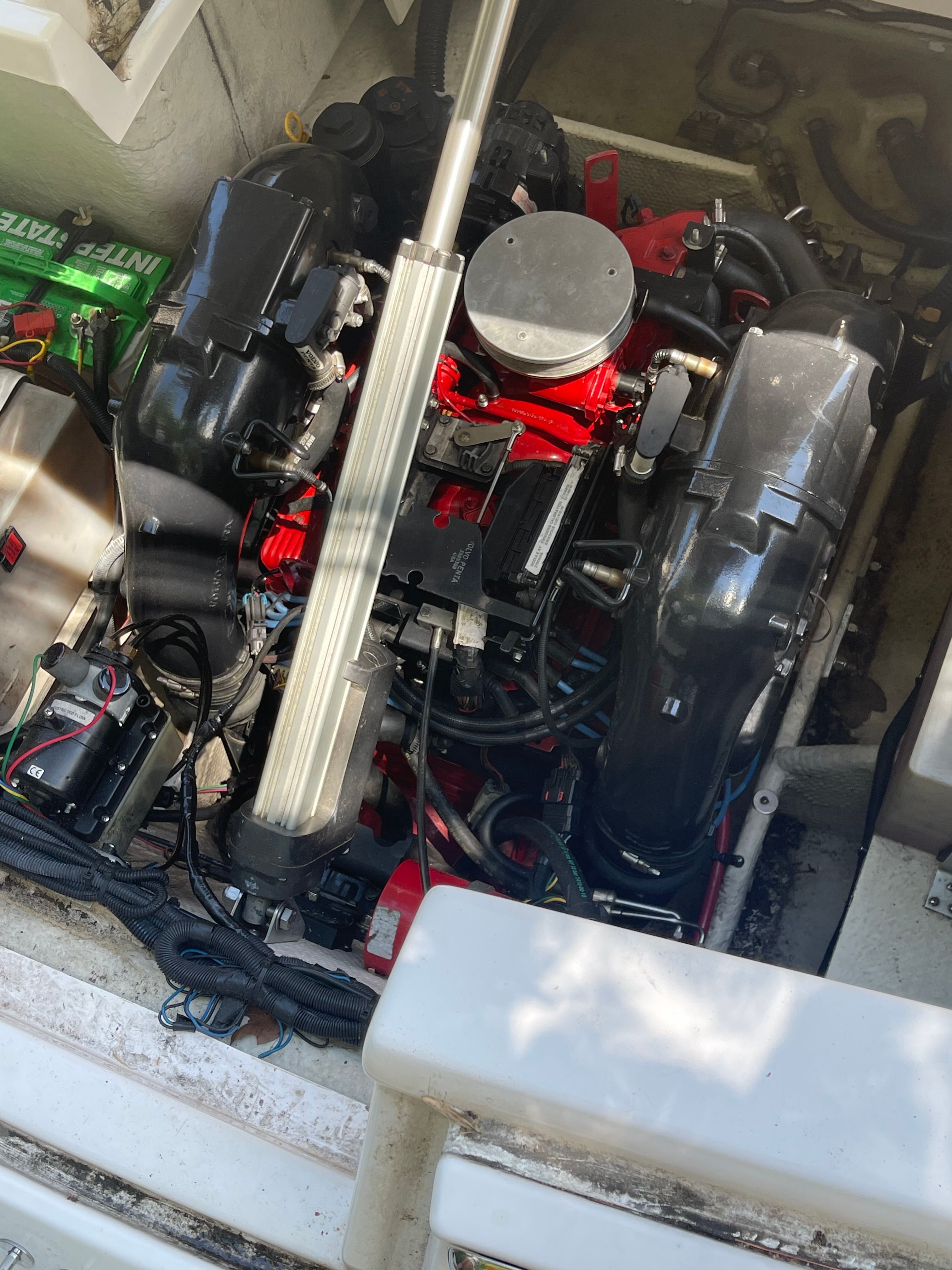 An engine compartment with a powerful engine, surrounded by cables and components.