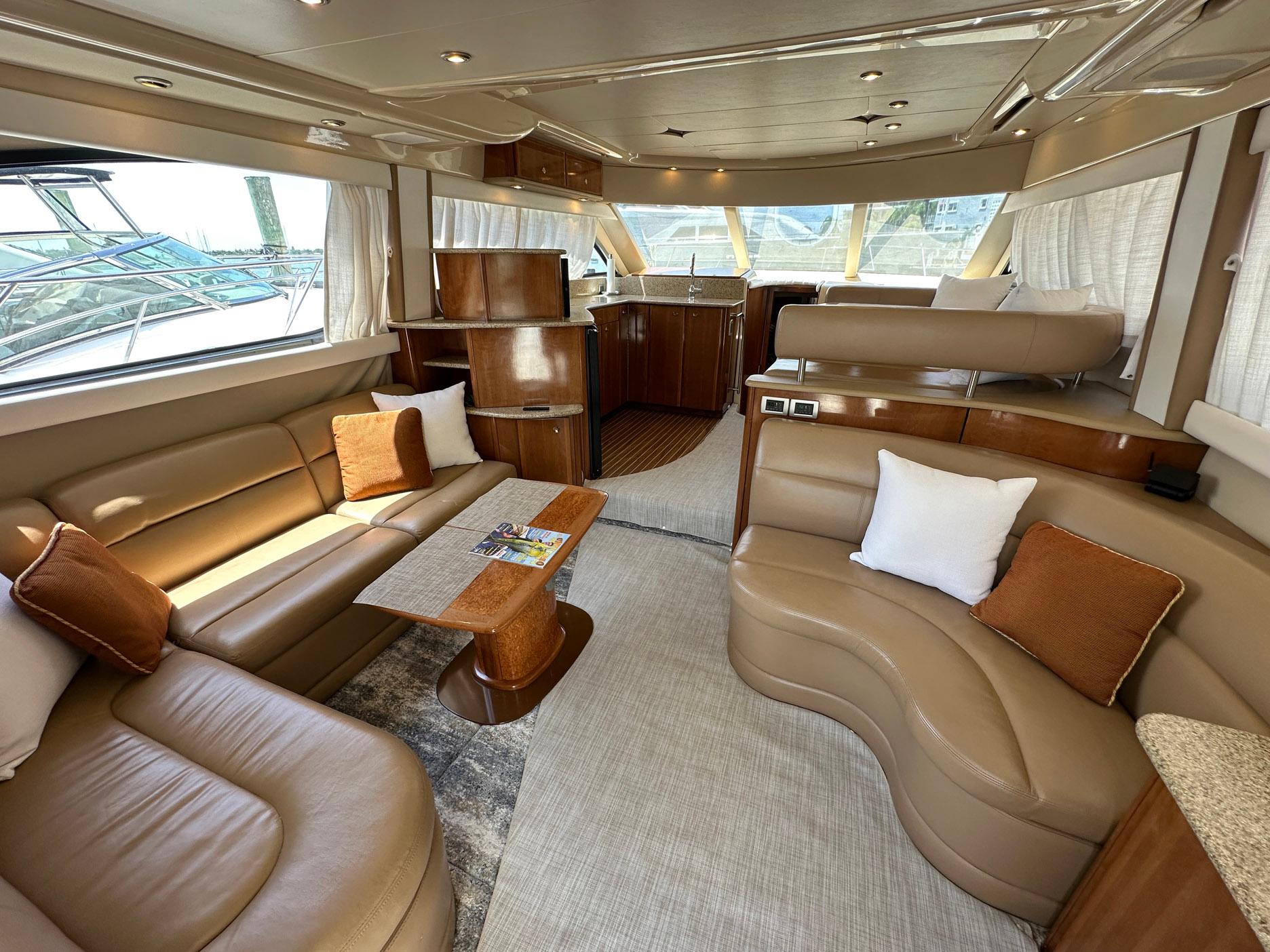 Luxurious interior of a 2007 Meridian 411 Sedan yacht with elegant seating and wood finishes.