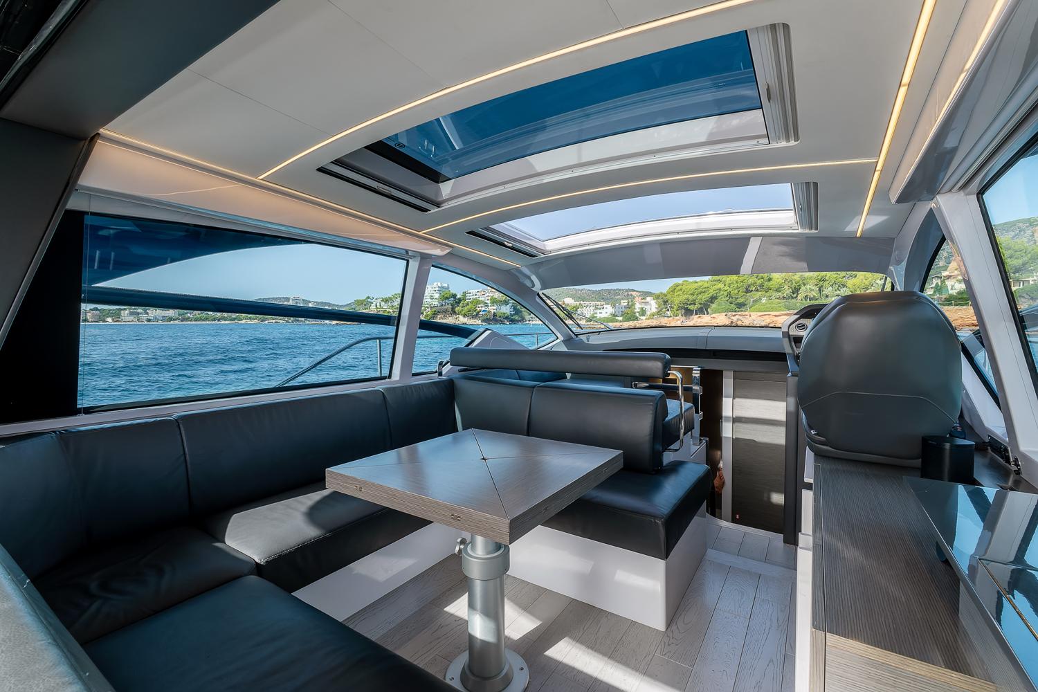 Interior of 2017 Pershing 5x yacht with sleek seating and panoramic windows.