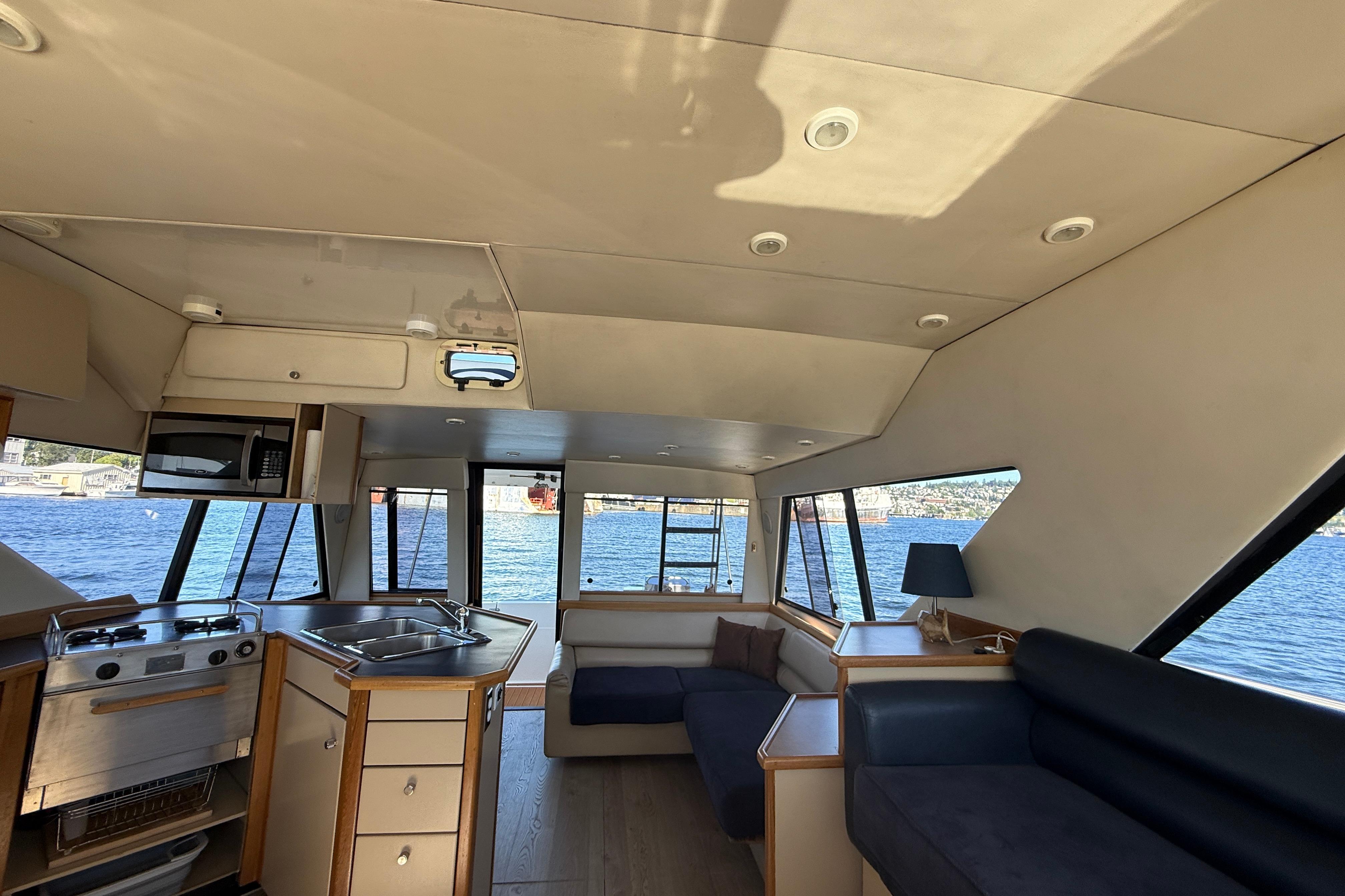 Interior of 1997 Bayliner 3988 Command Bridge Motoryacht with kitchen and seating area.