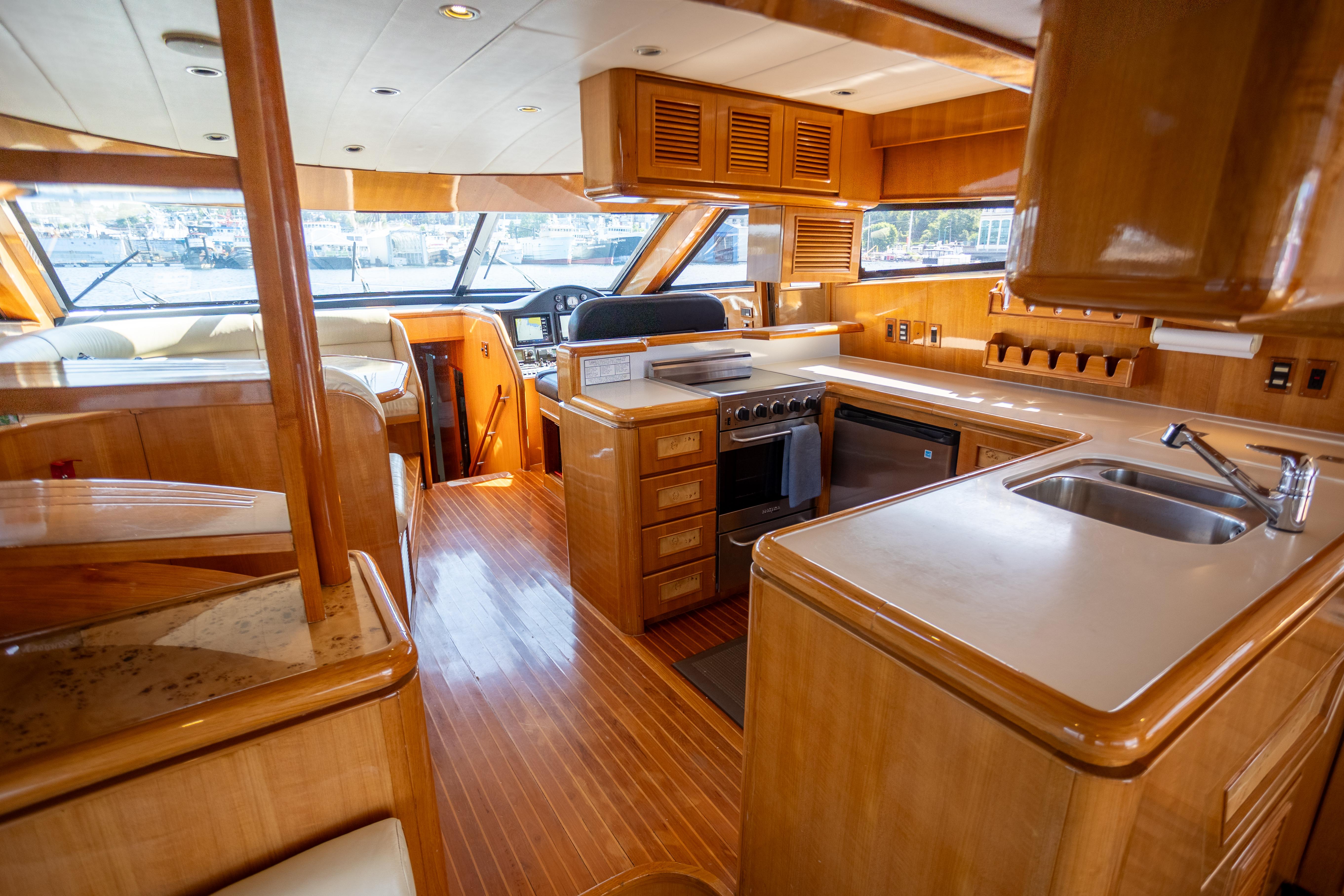 Luxurious 2001 Vitech 72 yacht interior with modern kitchen and helm station.