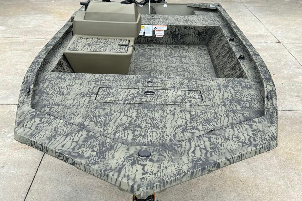 2026 Tracker Grizzly 1648 SC boat with camouflage pattern on concrete surface.