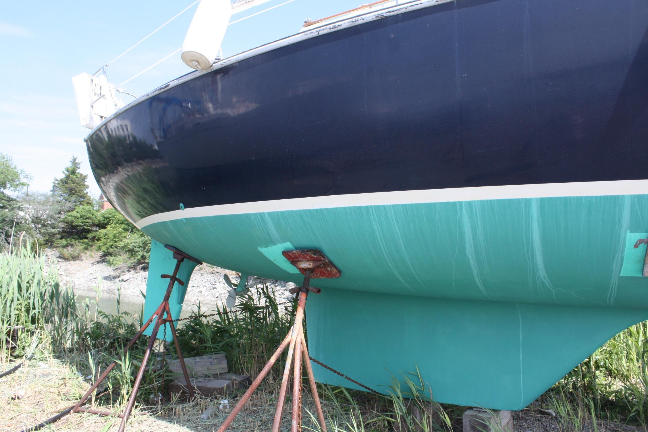 1981 S2 9.2A sailboat on stands, blue hull, outdoors.
