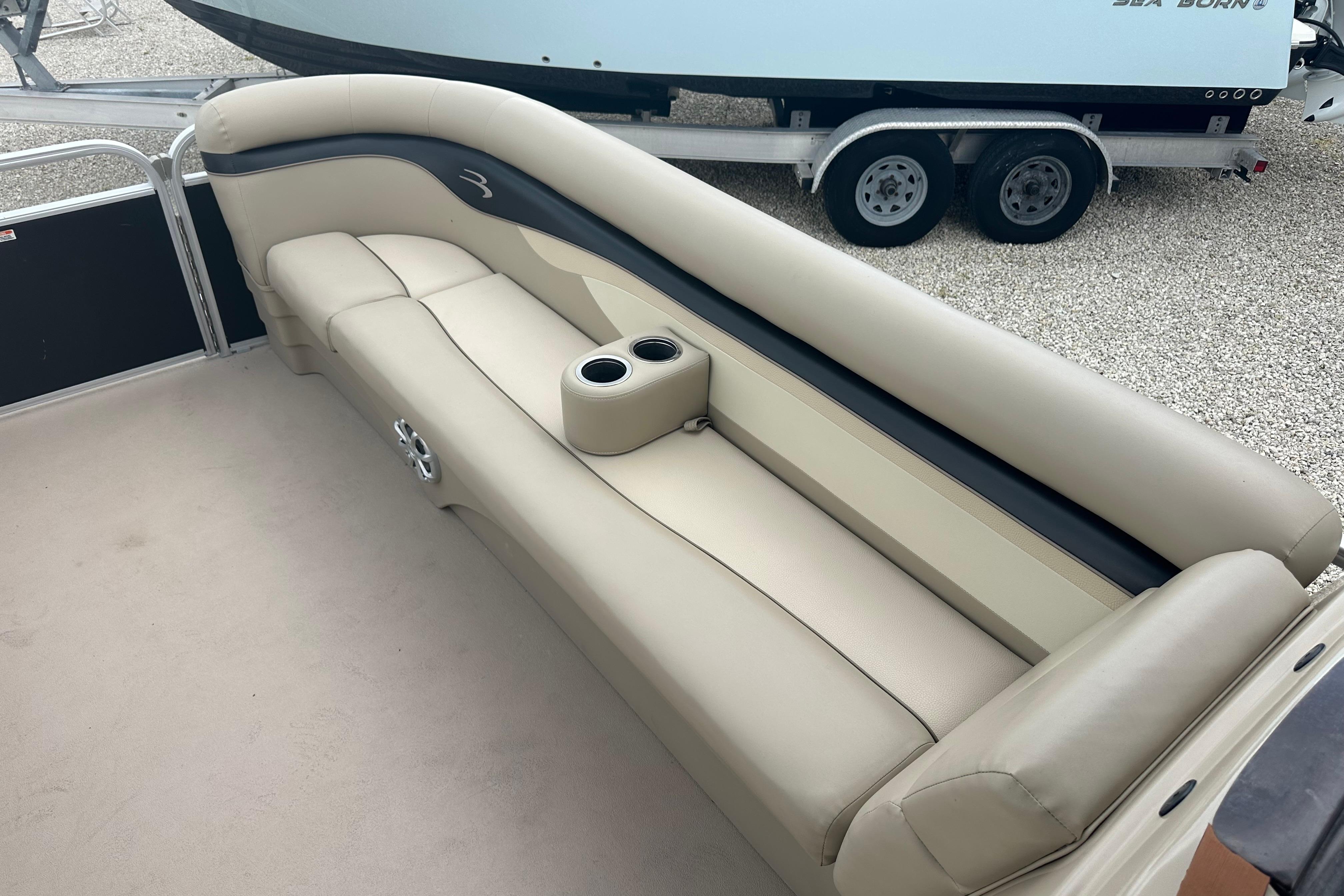 2014 Bennington S22 boat interior with beige seating and cup holders.