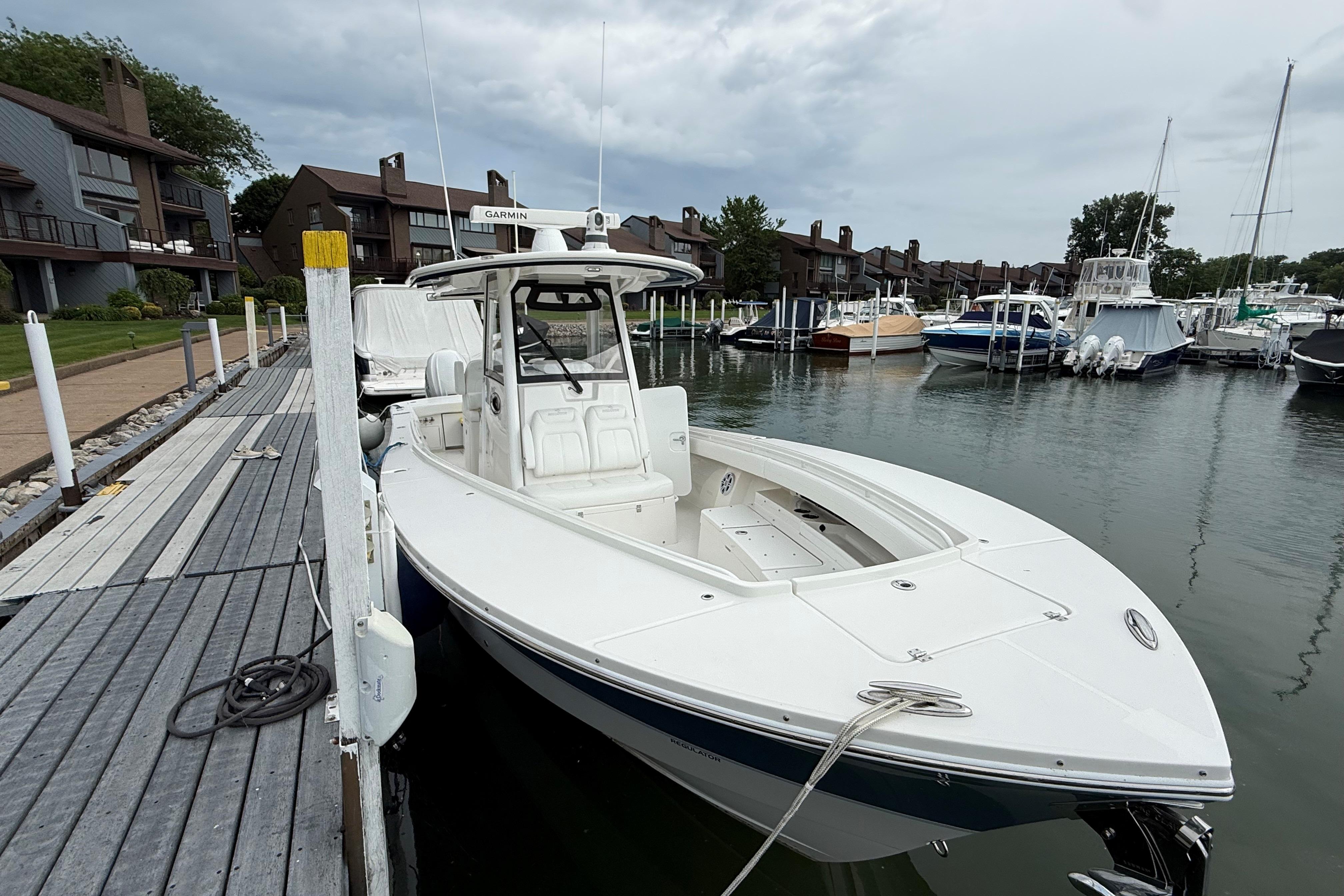 2021 Regulator 31 boat docked at a marina with overcast skies.