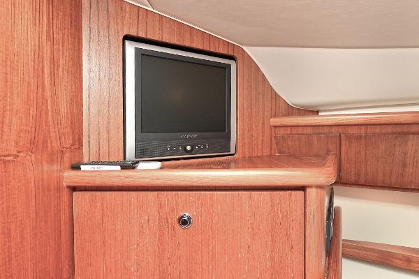 2008 Tiara Yachts 4200 Open interior with TV and wooden cabinetry.