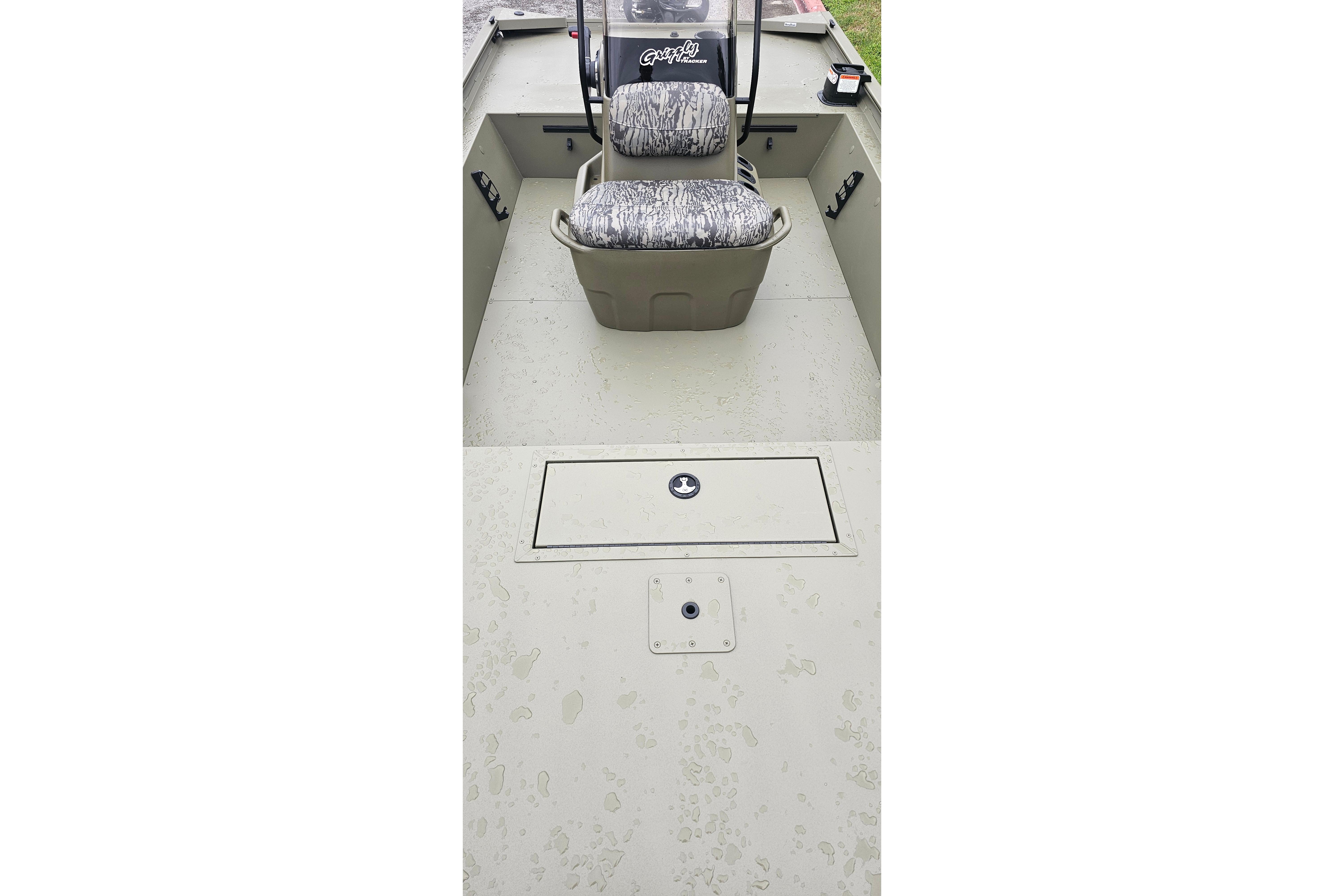 2026 Tracker Grizzly 1860 CC boat interior with camo seats and storage compartment.