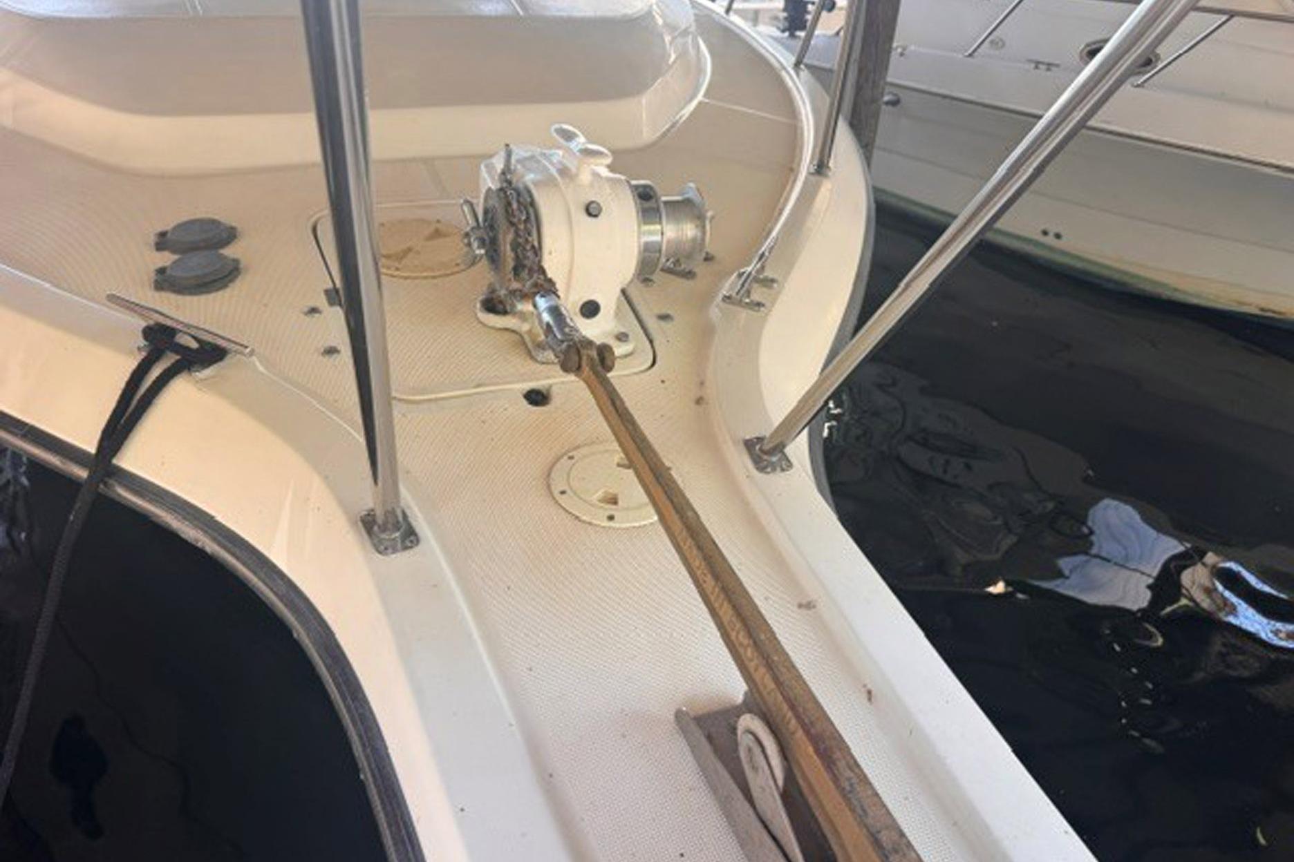 1988 Tiara Yachts 3300 Open deck with anchor winch and railing.