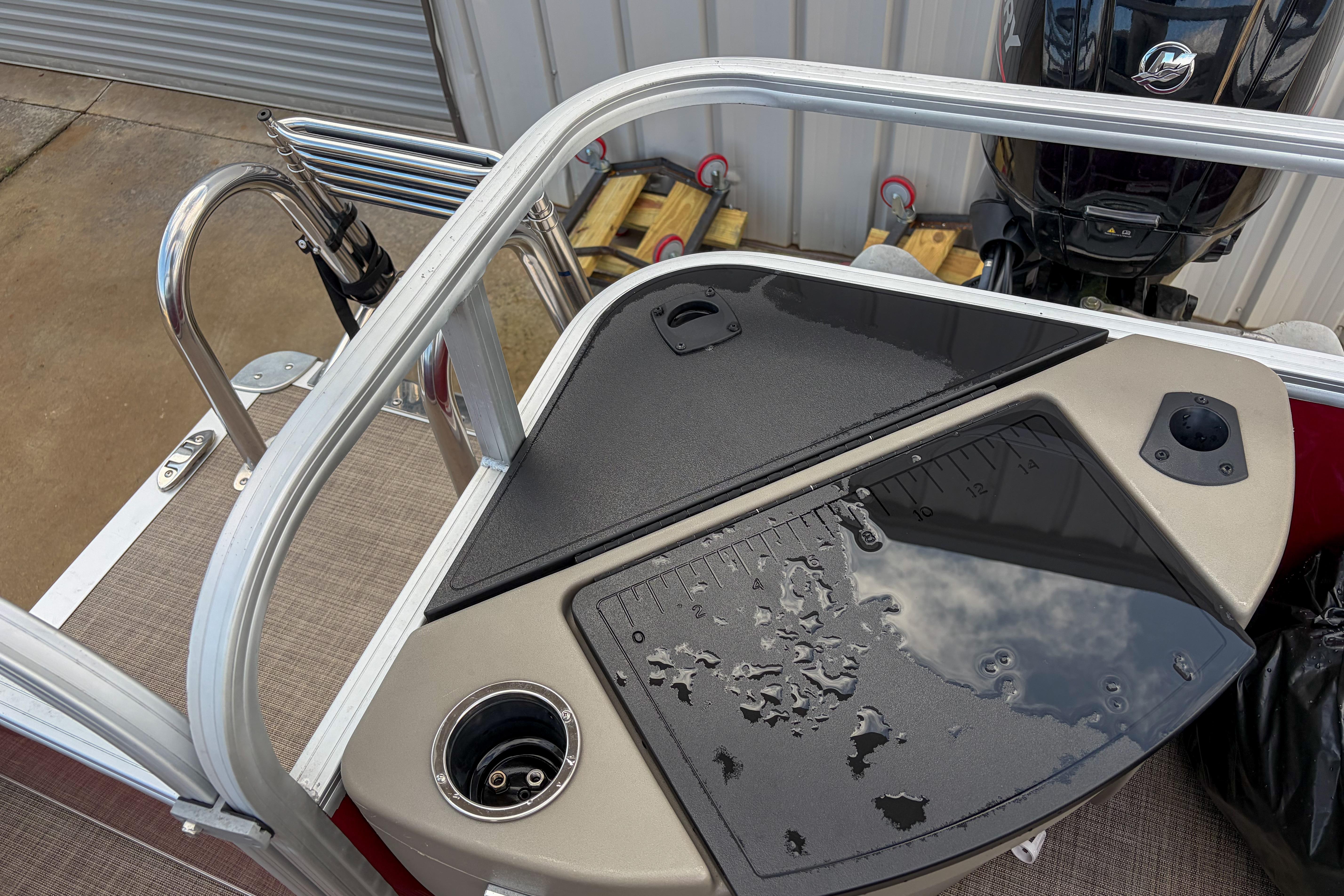 2024 Sun Tracker Bass Buggy 18 DLX fishing station with rod holders and measuring board.