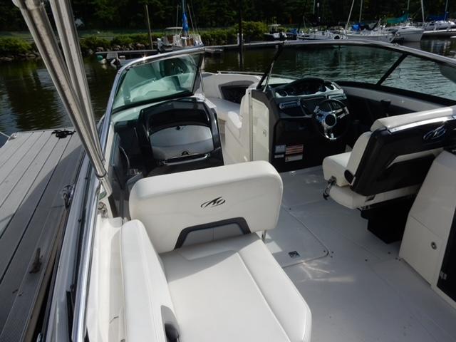2014 Monterey 288 Super Sport boat interior with white seating and steering console.