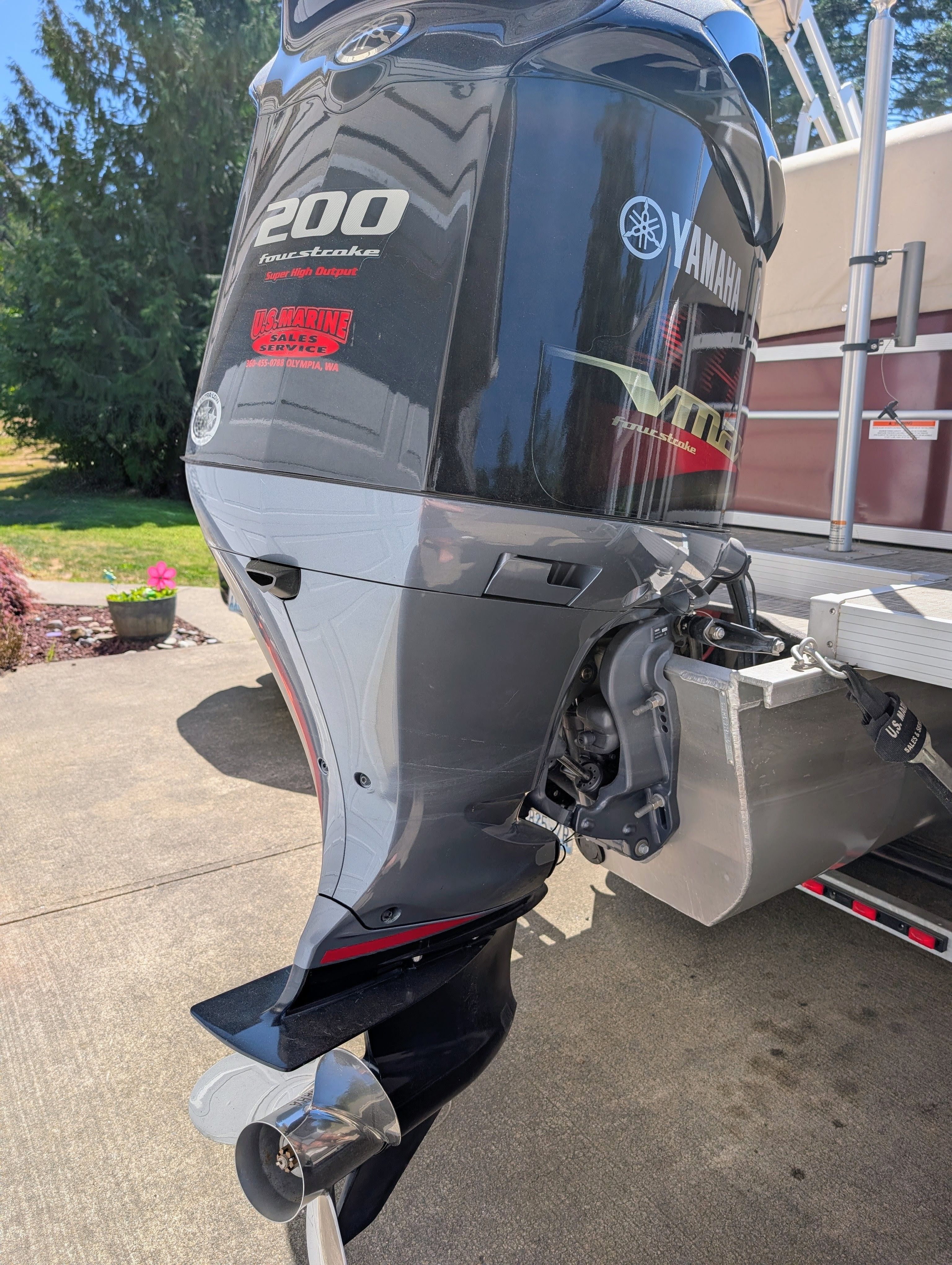 Outboard motor of a 2016 SunCatcher V322 GX, parked on a trailer.