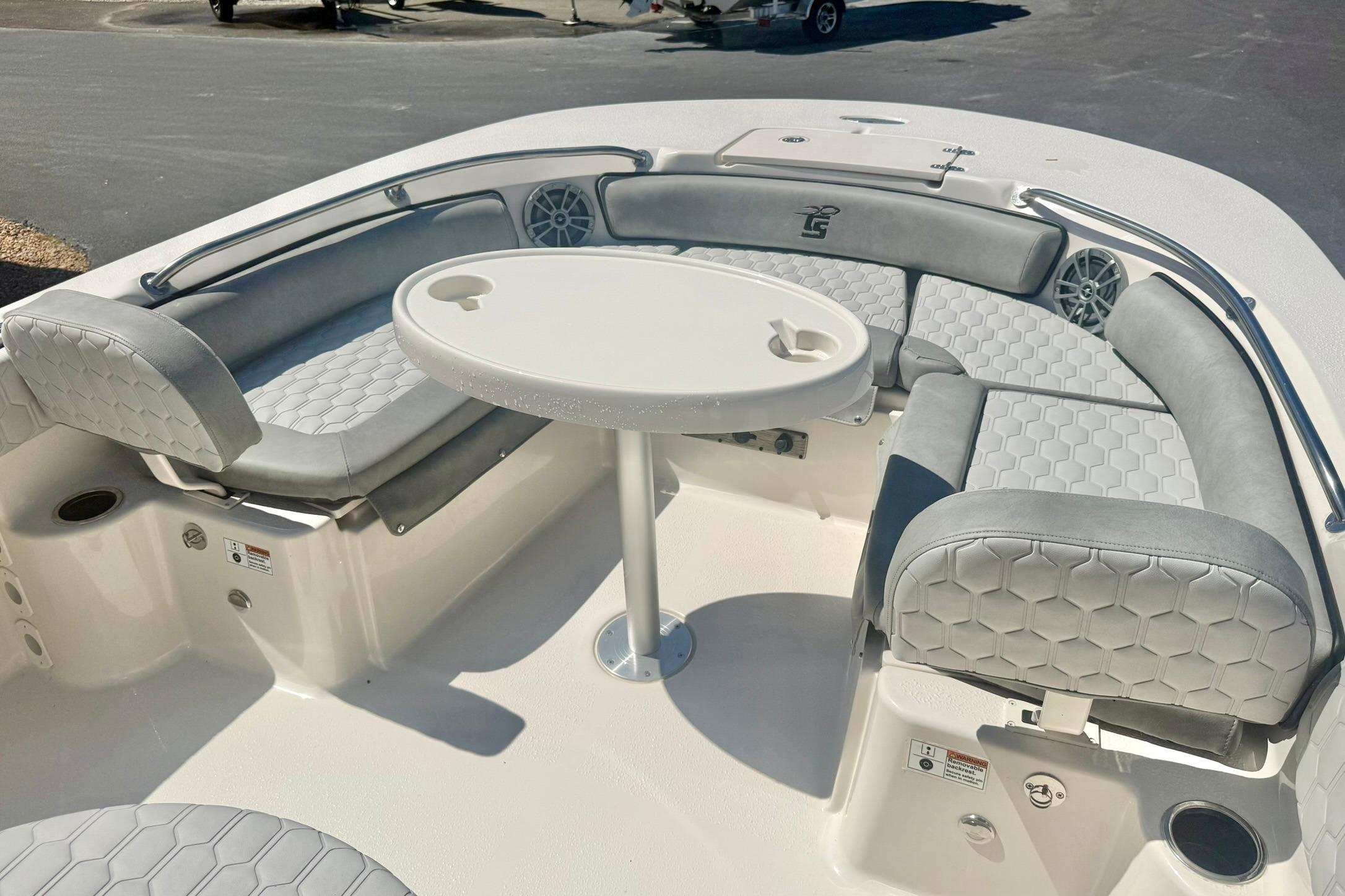 2026 Carolina Skiff 21 Ultra Elite boat interior with cushioned seating and round table.